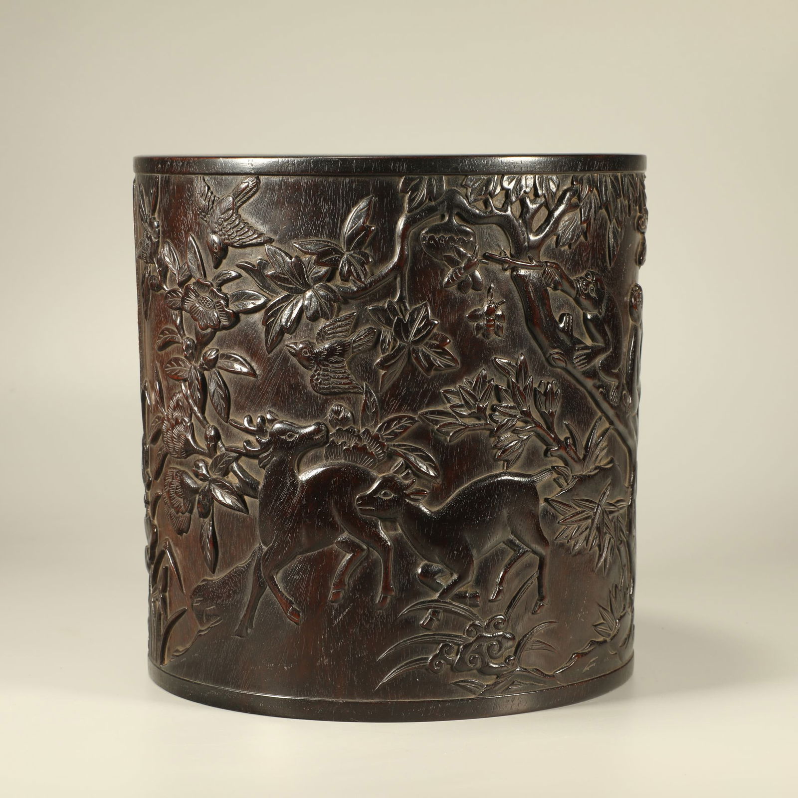 A ZITAN WOOD BRUSH POT CARVED WITH FLORAL, BIRD, AND POETIC MOTIFS: Zitan wood brush pot carved with floral, bird, and poetic motifs