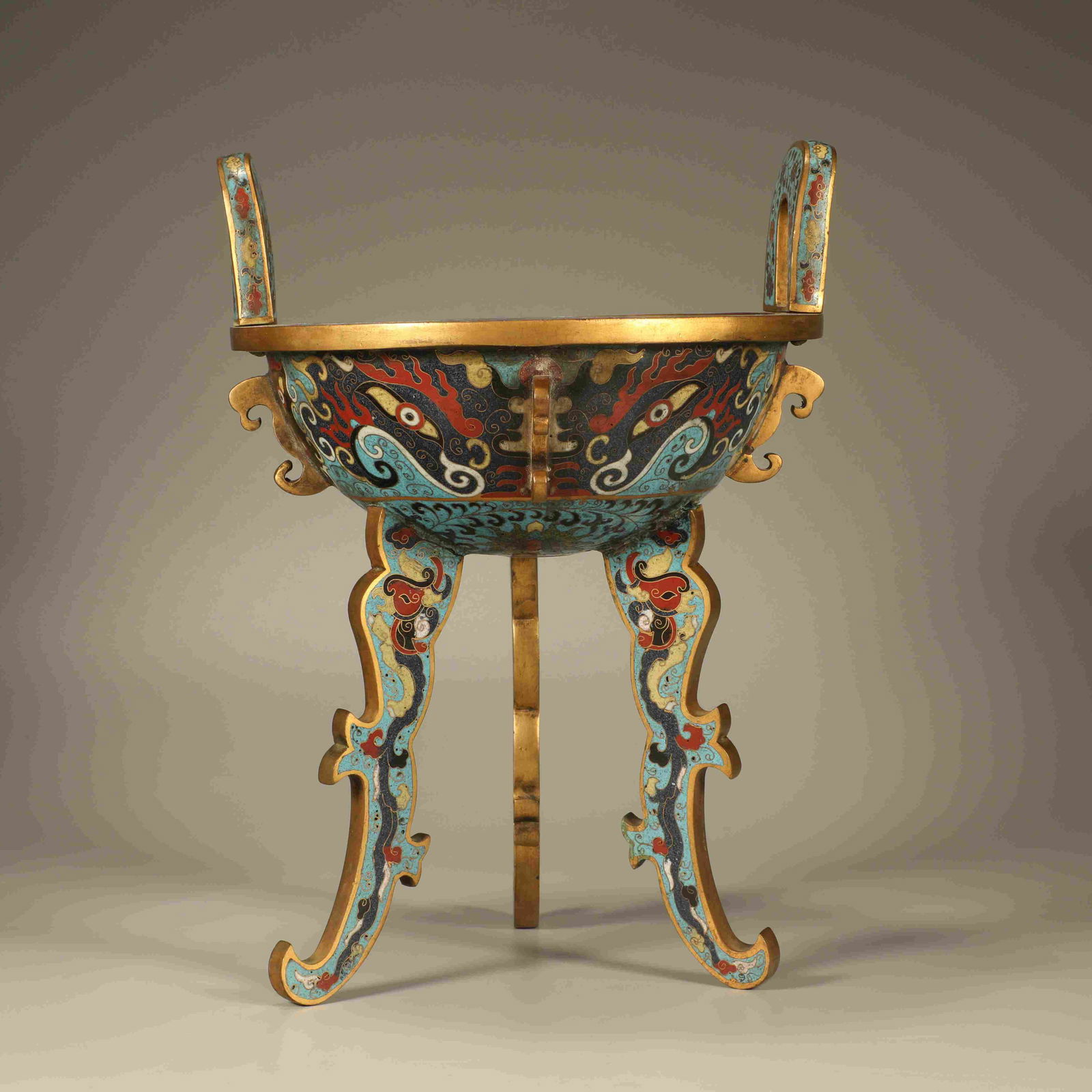 A CLOISONNÉ ENAMEL TRIPOD INCENSE BURNER WITH TAOTIE MASK MOTIFS: Cloisonné enamel tripod incense burner with taotie mask motifs