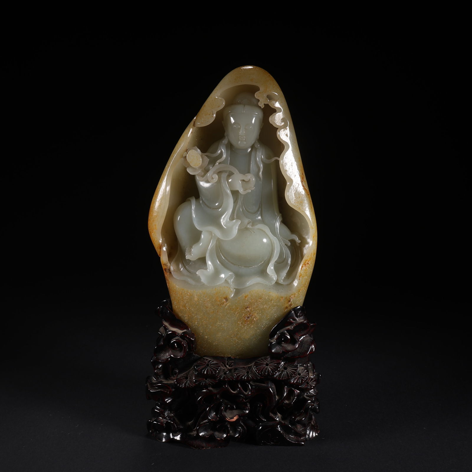 A HETIAN JADE SEATED GUANYIN HOLDING A RUYI ON WOODEN STAND, MOUNTAIN SCULPTURE (1 of 9)