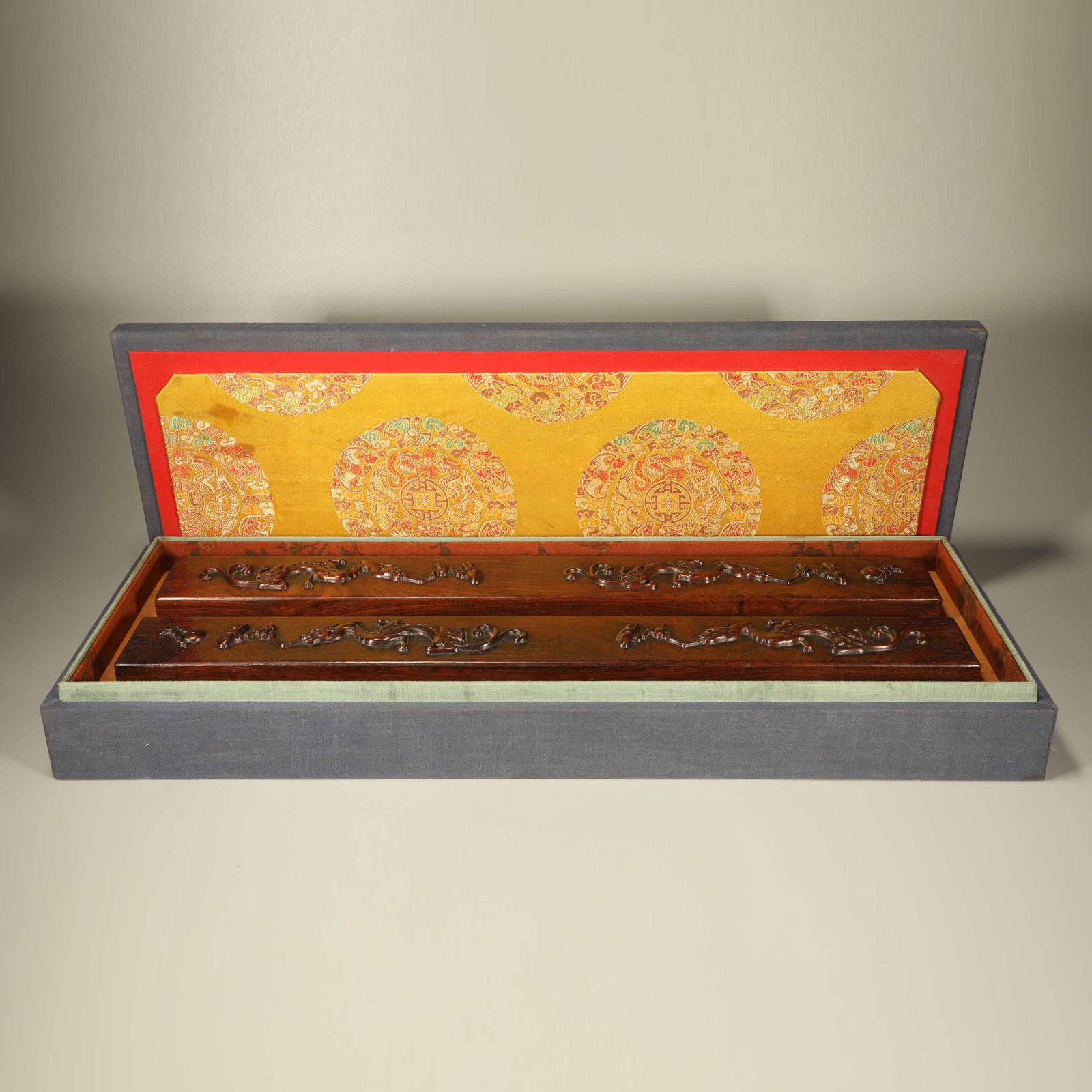 A HUANGHUALI WOOD PAPERWEIGHTS CARVED WITH TWO DRAGONS CHASING A PEARL, PAIR (1 of 6)