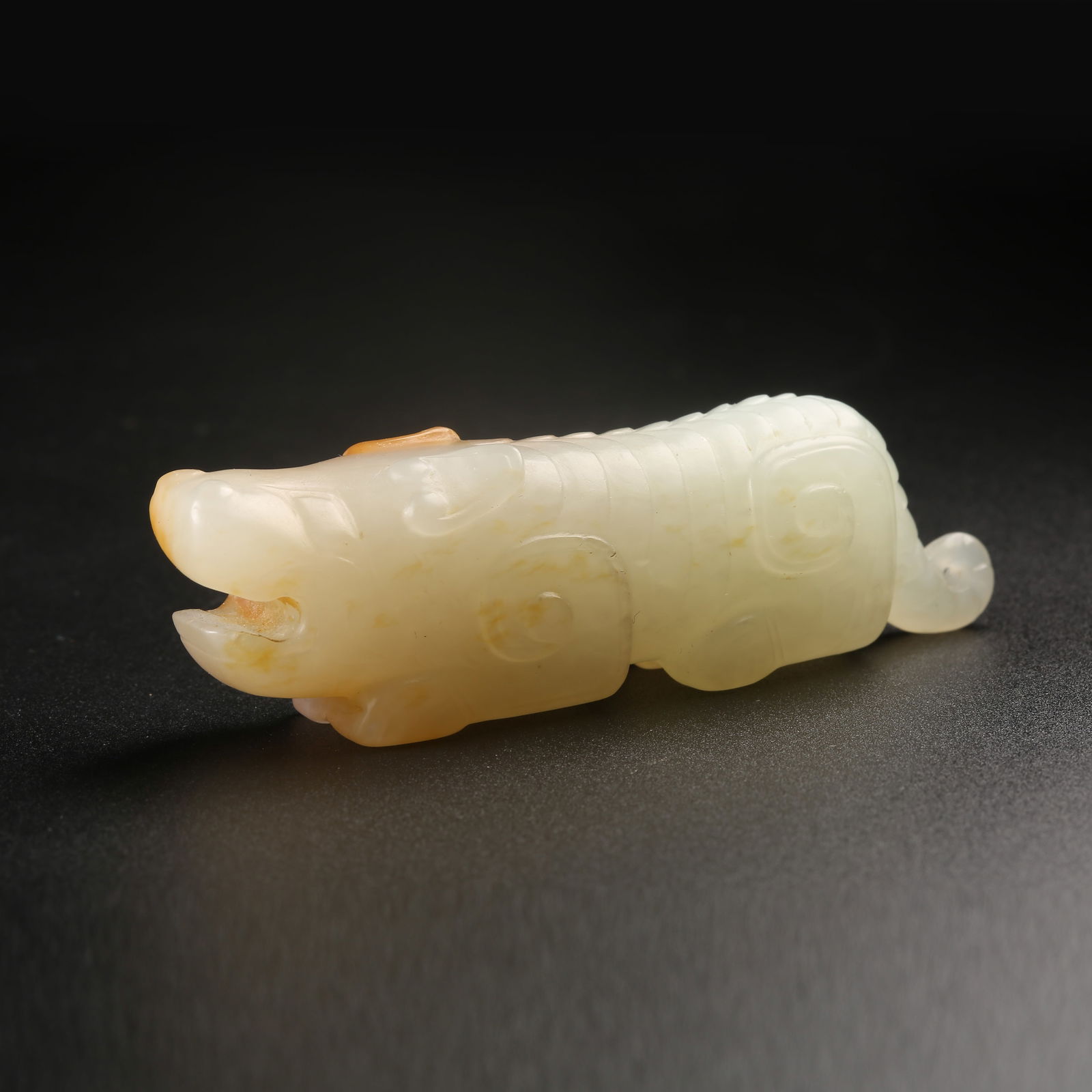 A HETIAN JADE AUSPICIOUS BEAST ORNAMENT (1 of 9)