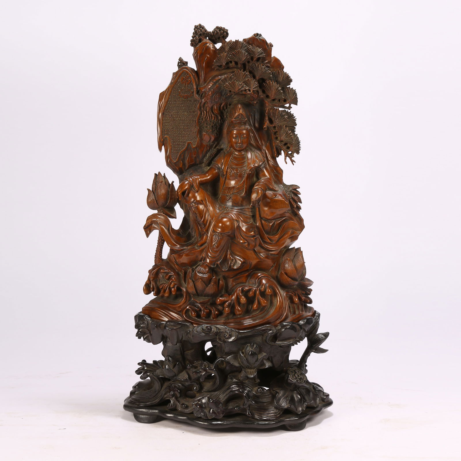 A SANDALWOOD FREE-FORM GUANYIN FIGURINE (1 of 9)