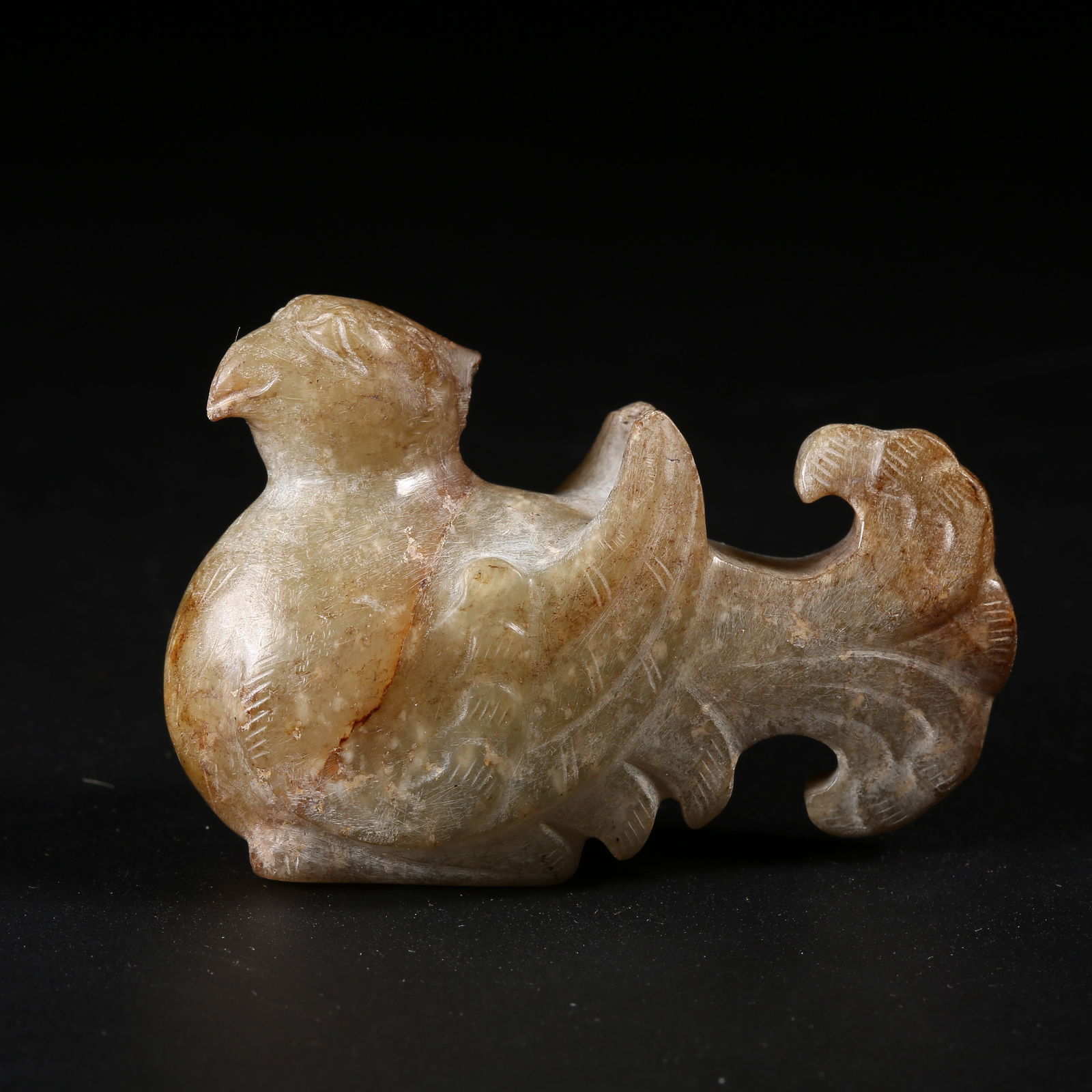 A ARCHAIC JADE DIVINE PHOENIX FIGURINE (1 of 7)