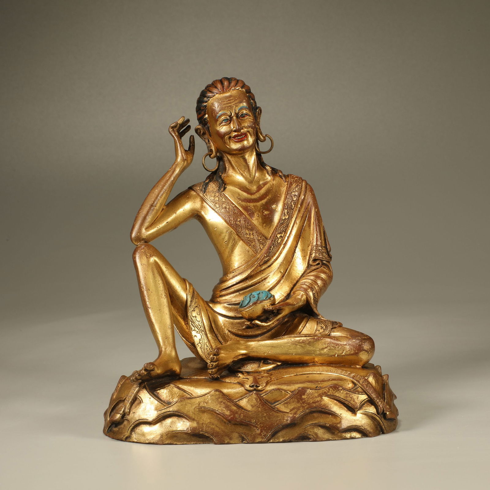 A GILT-BRONZE FIGURE OF THE VENERABLE MILAREPA: Gilt-bronze figure of the venerable Milarepa
