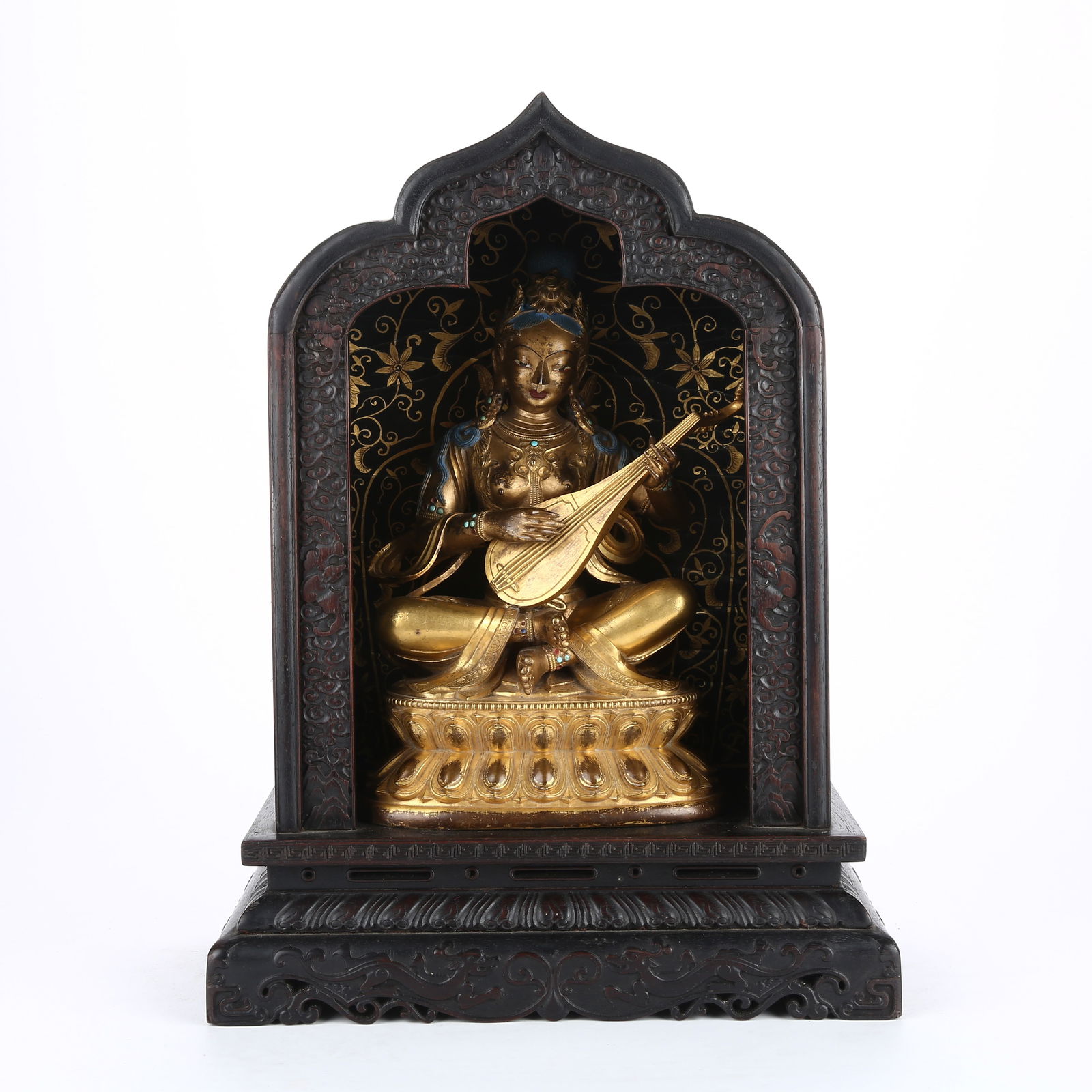A GILT BRONZE STATUE OF SARASVATI WITH ZITAN WOOD NICHE: Gilt Bronze Statue of Sarasvati with Zitan Wood Niche