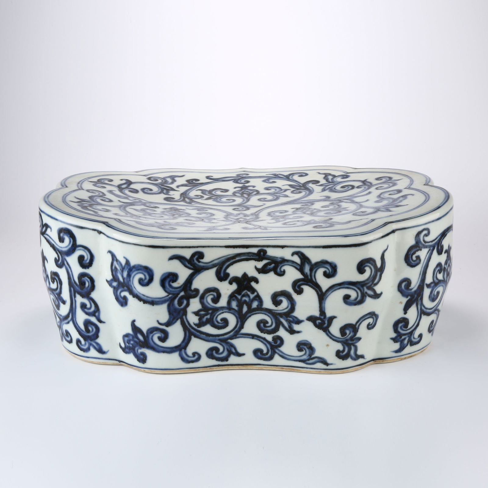 A BLUE AND WHITE PILLOW WITH SCROLL DESIGN: Blue and White Pillow with Scroll Design