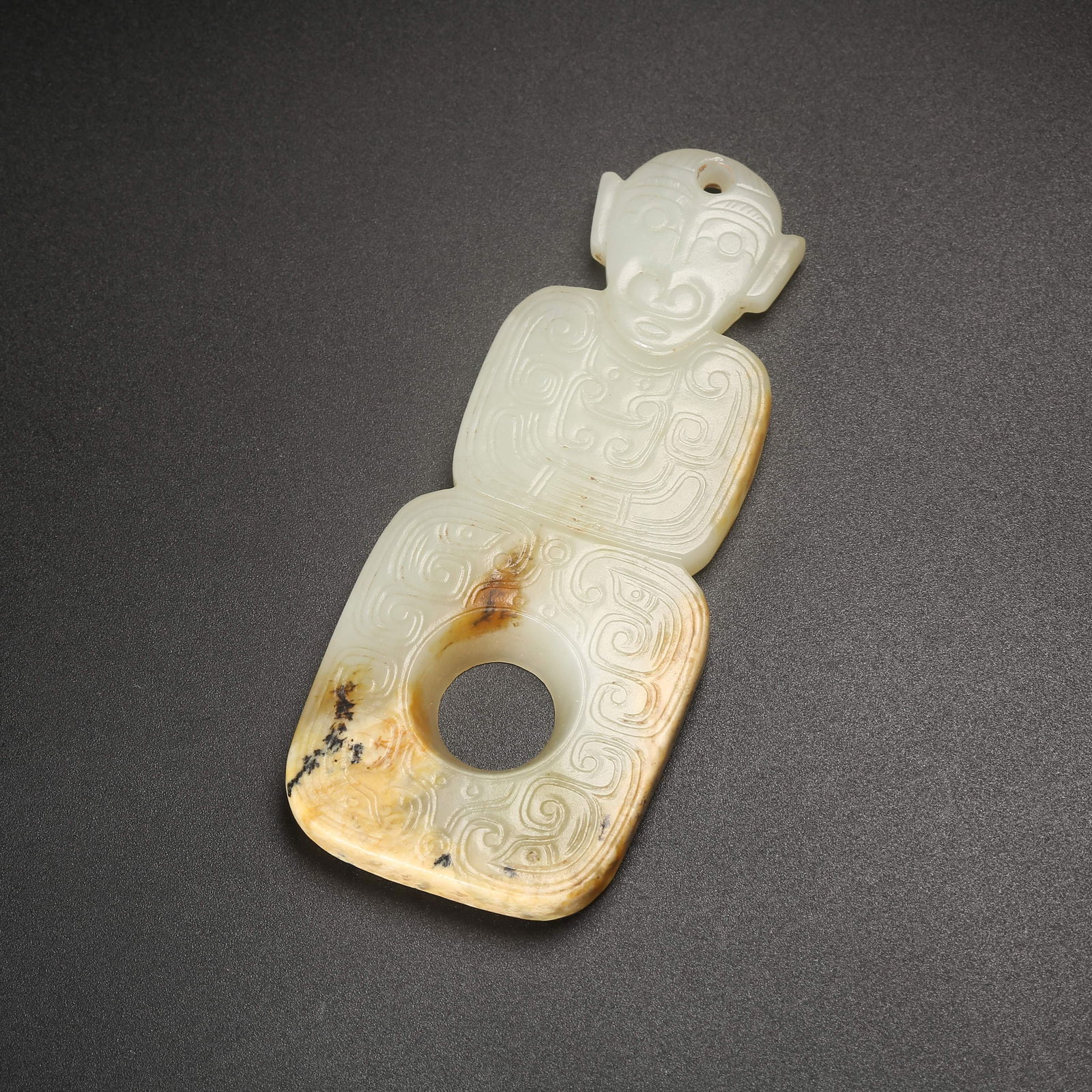 A ARCHAIC JADE DEITY PENDANT (1 of 9)