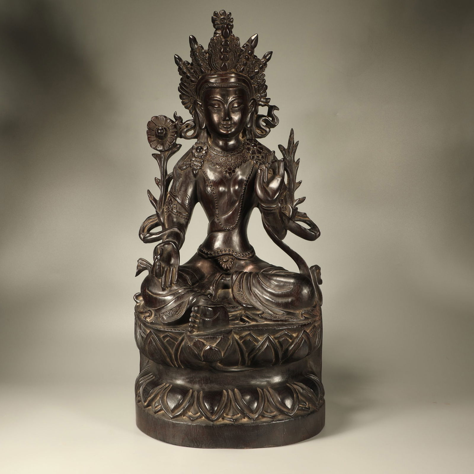 A ZITAN WOOD SEATED FIGURE OF GUANYIN: Zitan wood seated figure of Guanyin