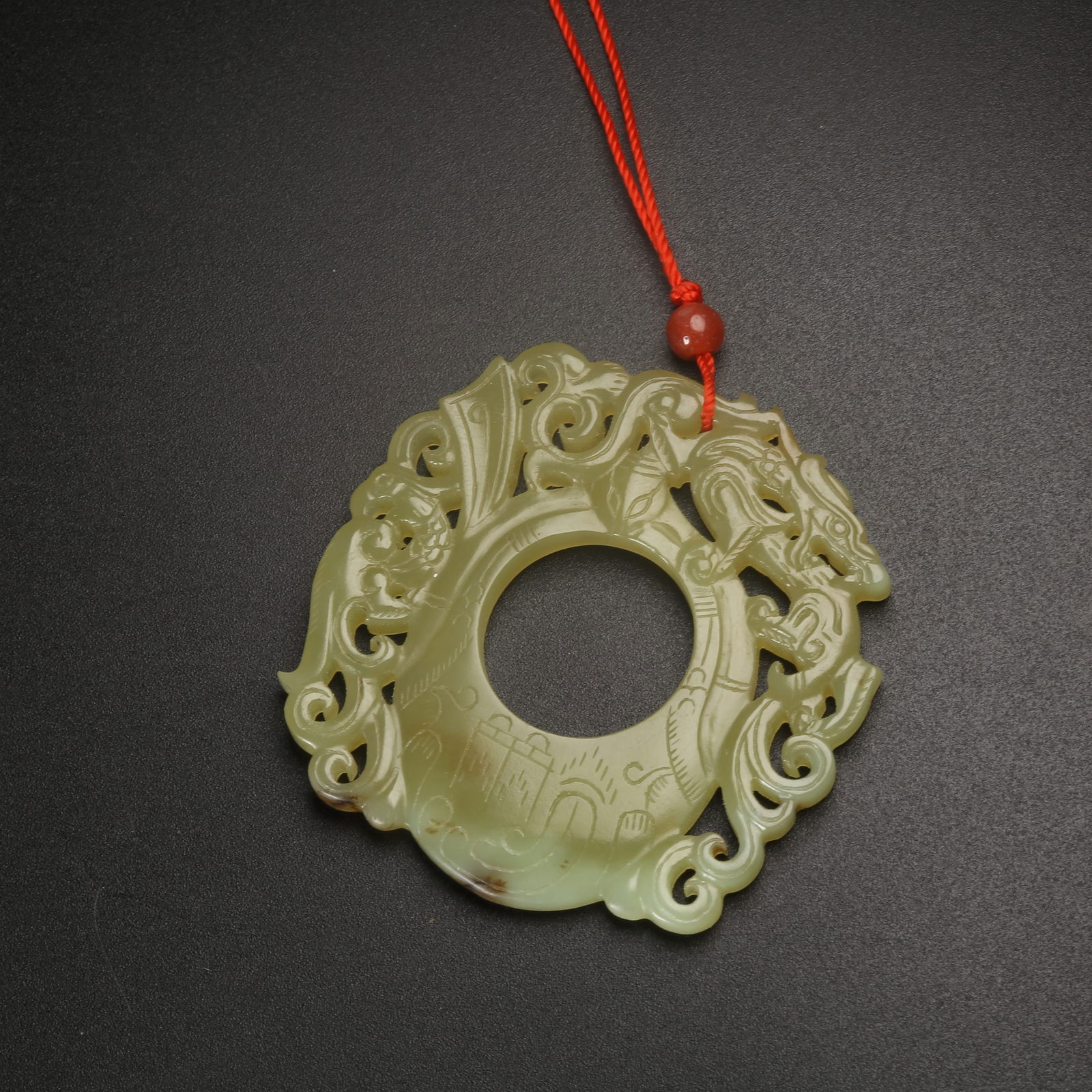 A HETIAN YELLOW JADE CHICKEN-HEART PENDANT WITH CHI-DRAGON MOTIF (1 of 9)