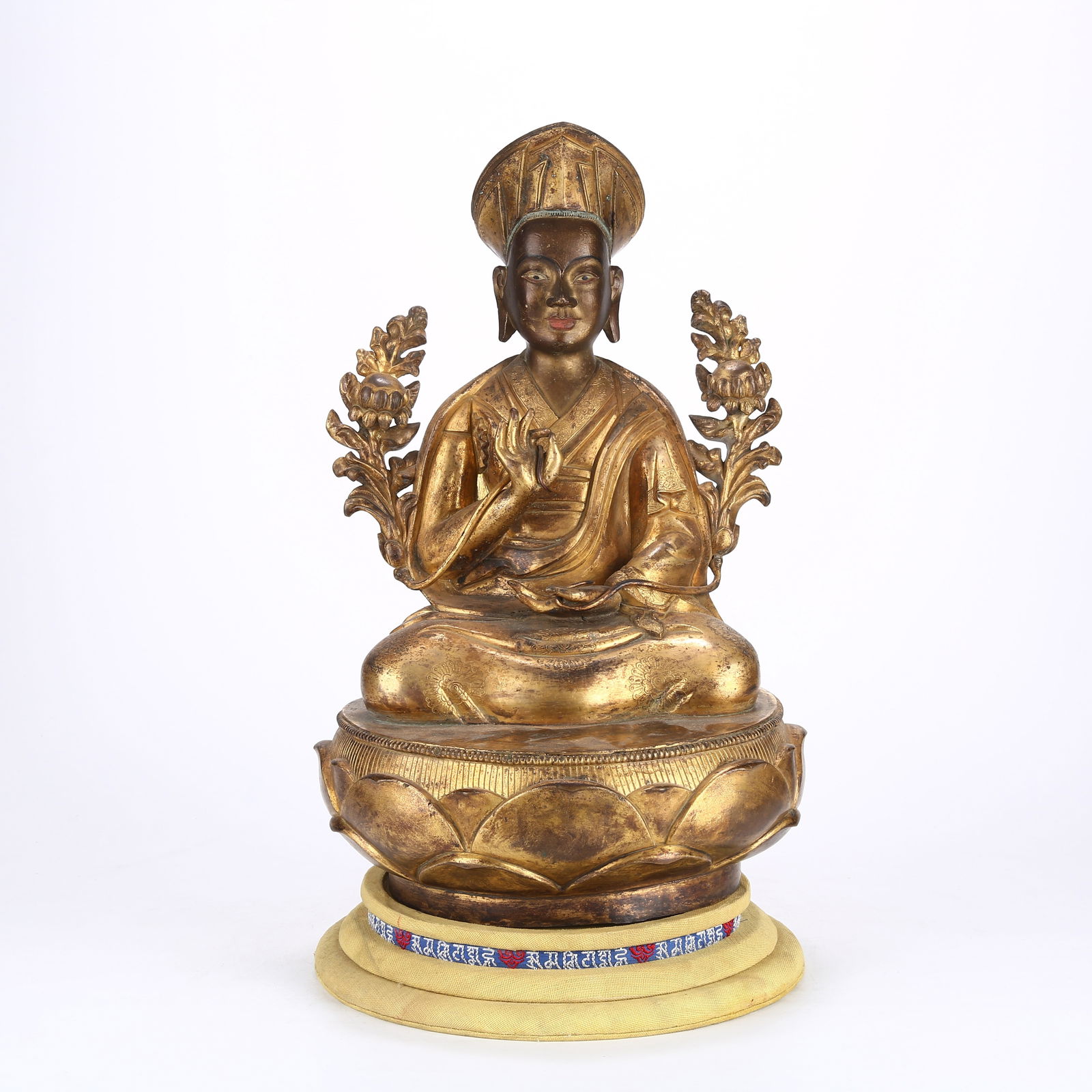 A GILT BRONZE STATUE OF A LAMA: Gilt Bronze Statue of a Lama