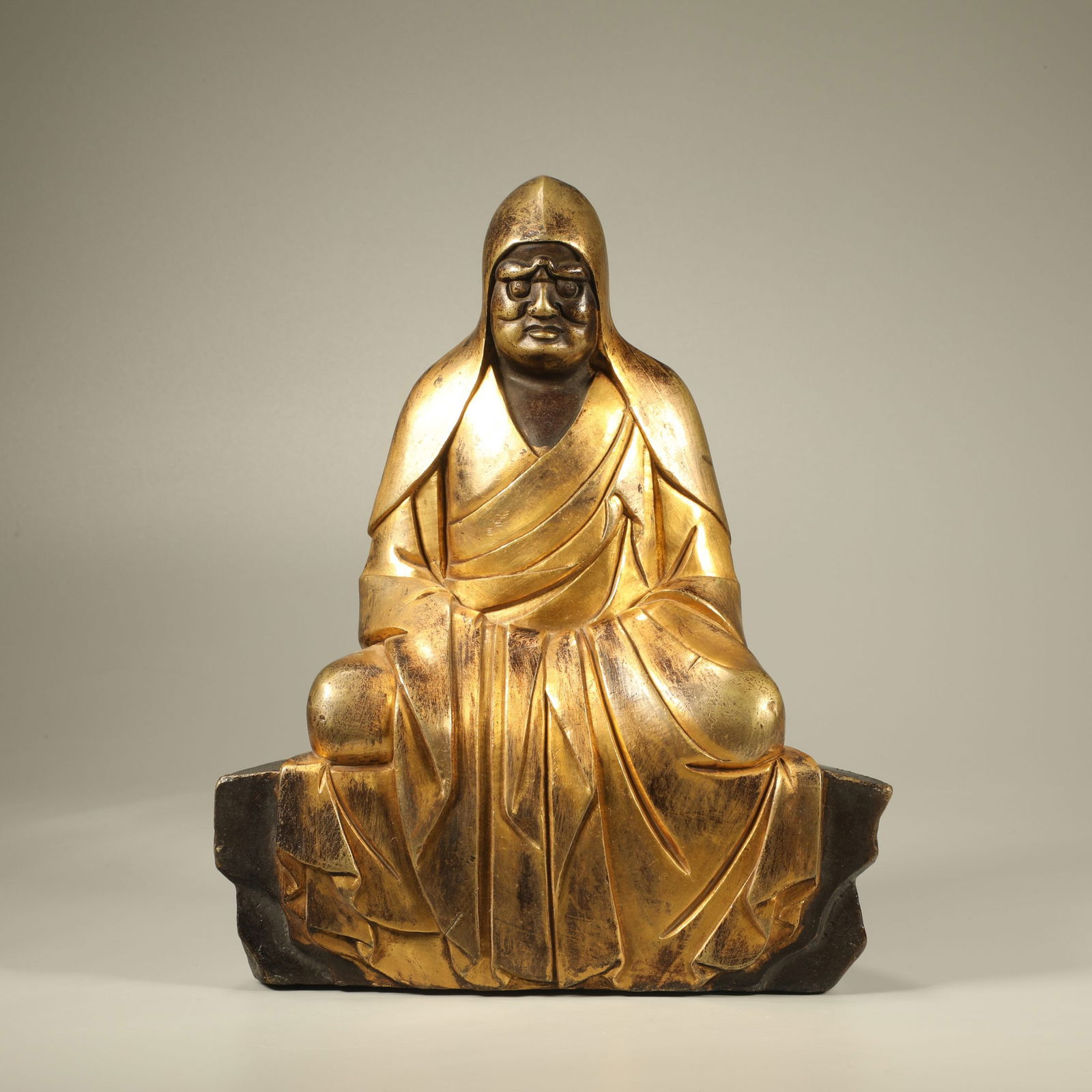 A GILT-BRONZE FIGURE OF A VENERABLE MONK (1 of 6)