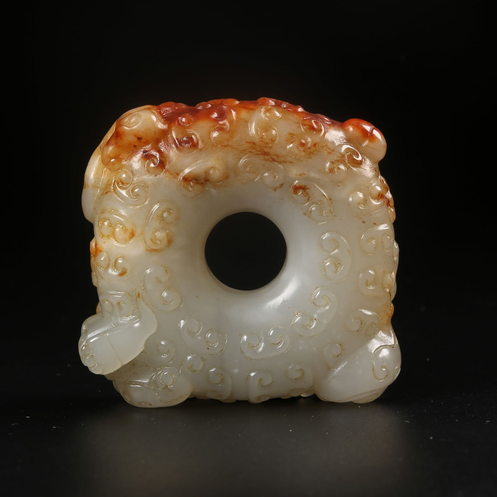 A ARCHAIC JADE BI-RING CARVED WITH DRAGON MOTIFS: Archaic jade bi-ring carved with dragon motifs