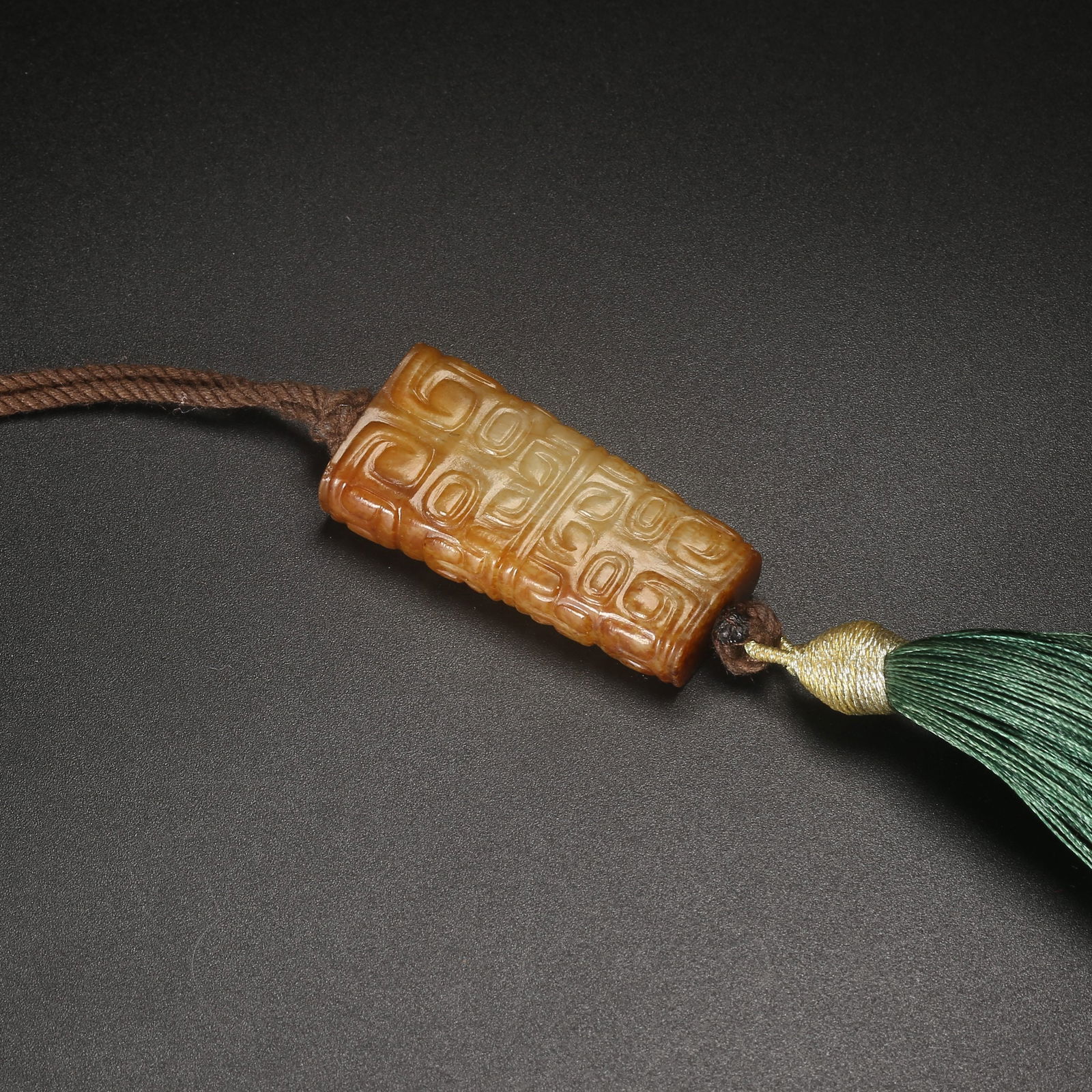 A ARCHAIC JADE BELT HOOK WITH DEITY FACE MOTIF (1 of 8)