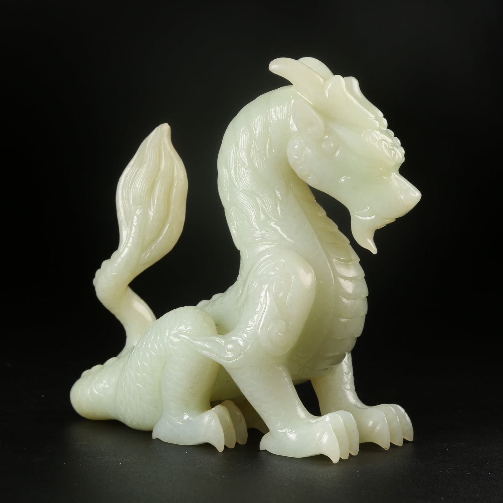 A HETIAN JADE SITTING DRAGON ORNAMENT (1 of 9)