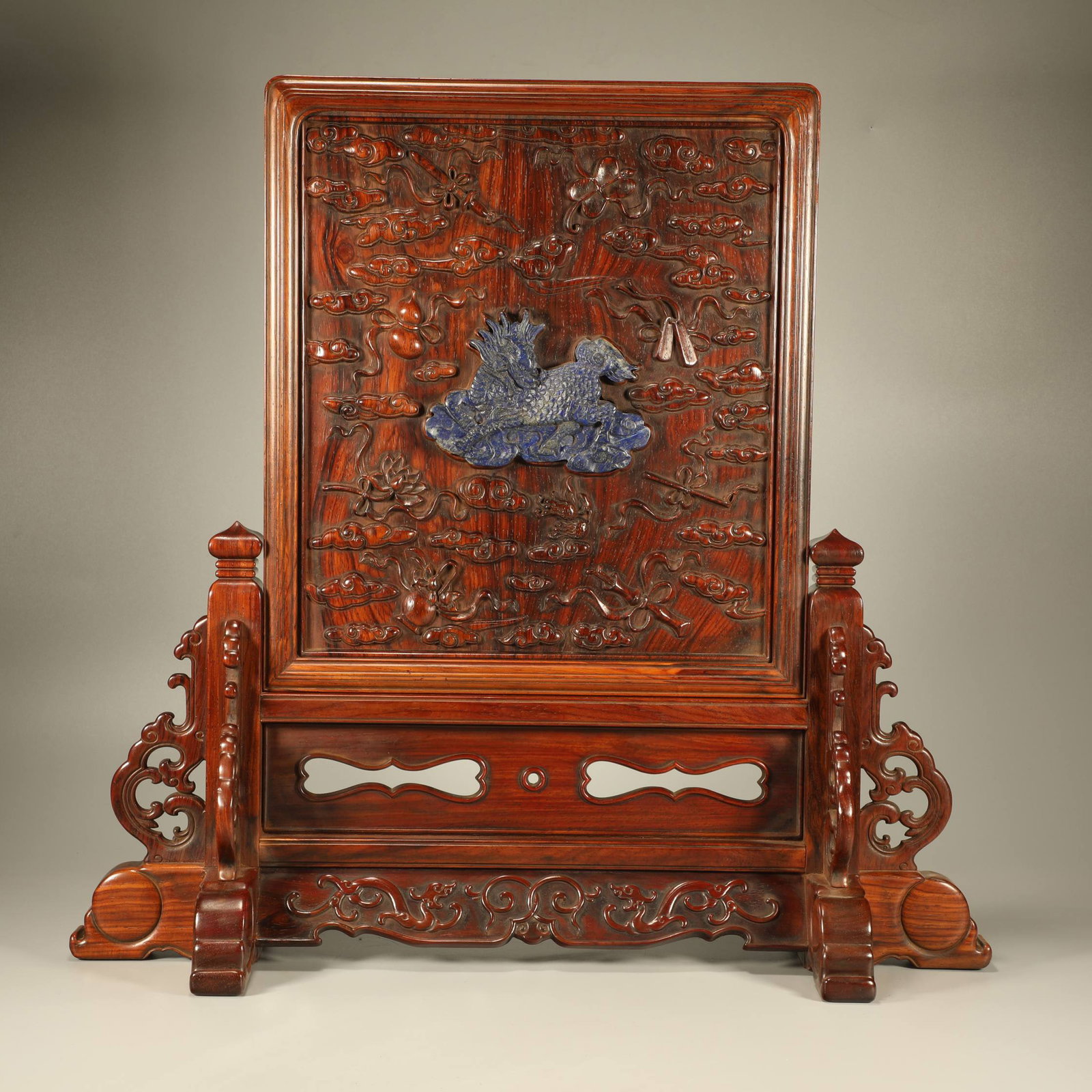 A HUANGHUALI WOOD SCREEN CARVED WITH THE EIGHT AUSPICIOUS EMBLEMS AND INLAID WITH LAPIS LAZULI, (1 of 7)