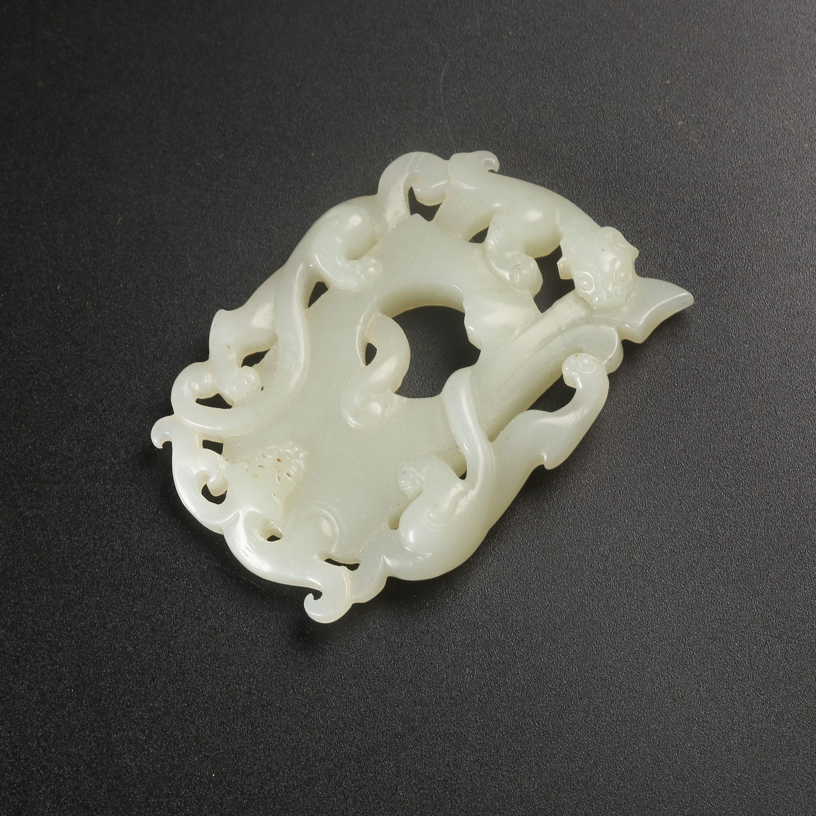 A HETIAN JADE CHICKEN-HEART PENDANT WITH CHI-DRAGON MOTIF (1 of 11)