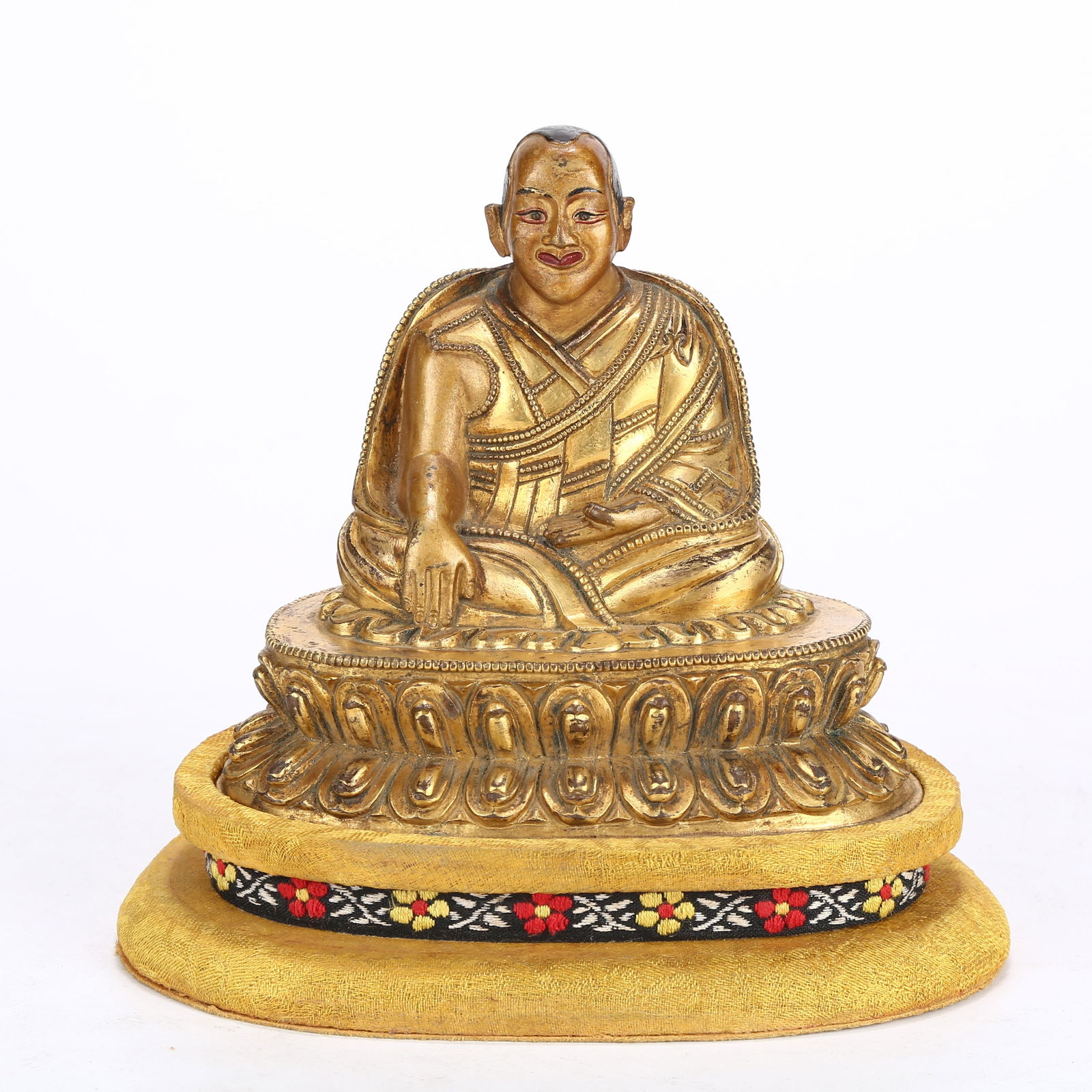 A GILT BRONZE STATUE OF A LAMA: Gilt Bronze Statue of a Lama