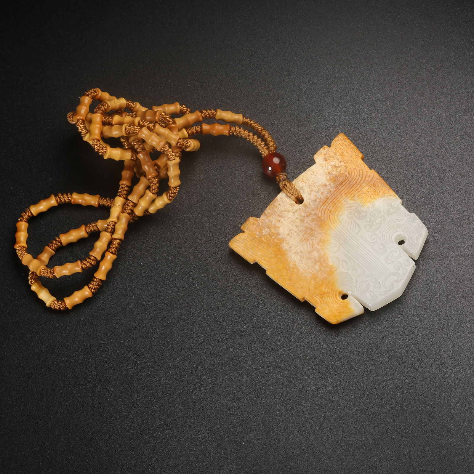 A ARCHAIC JADE BEAST-FACE MOTIF PENDANT: Archaic Jade Beast-Face Motif Pendant