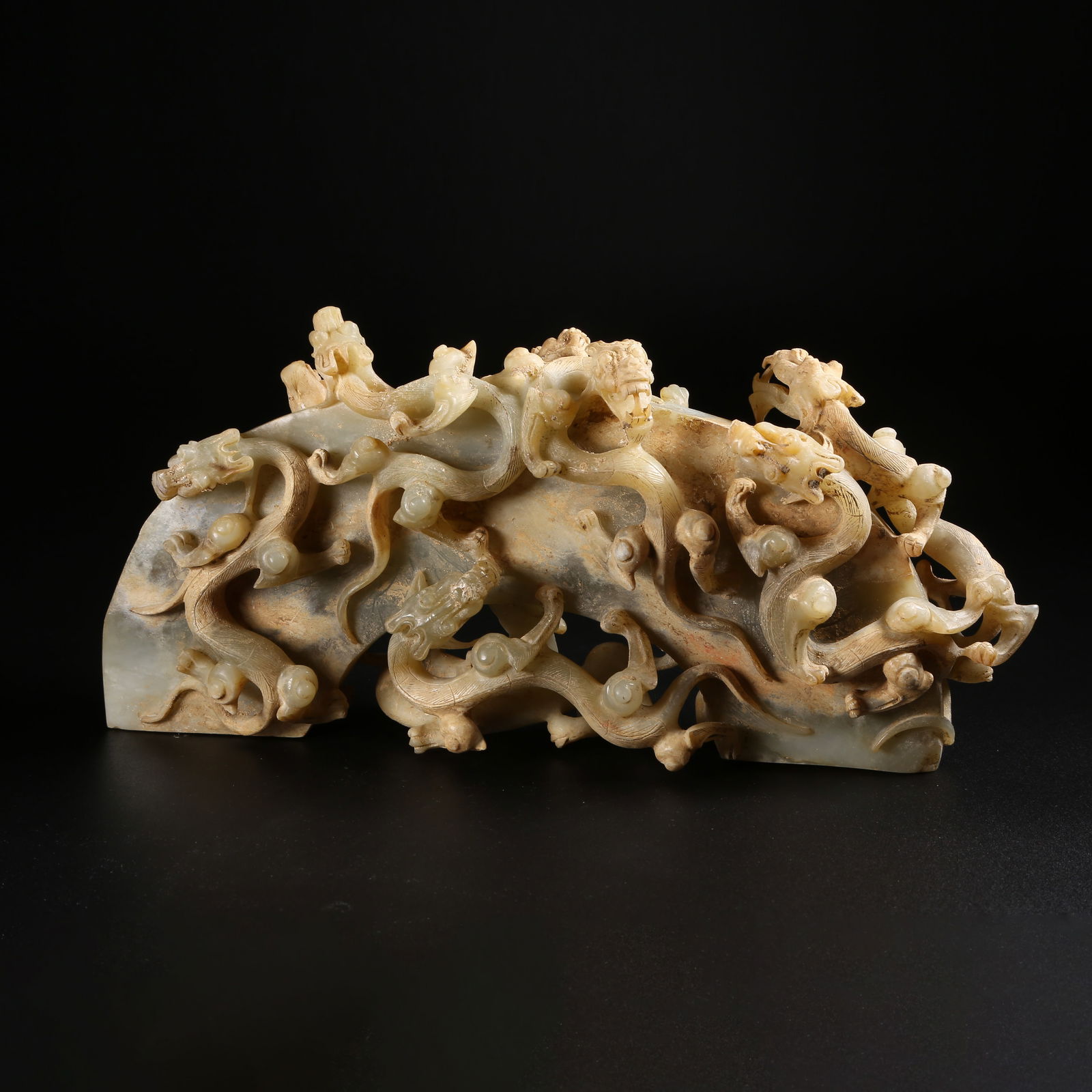 A ARCHAIC JADE ORNAMENT WITH CHILONG (COILED DRAGON) MOTIF: Archaic jade ornament with chilong (coiled dragon) motif