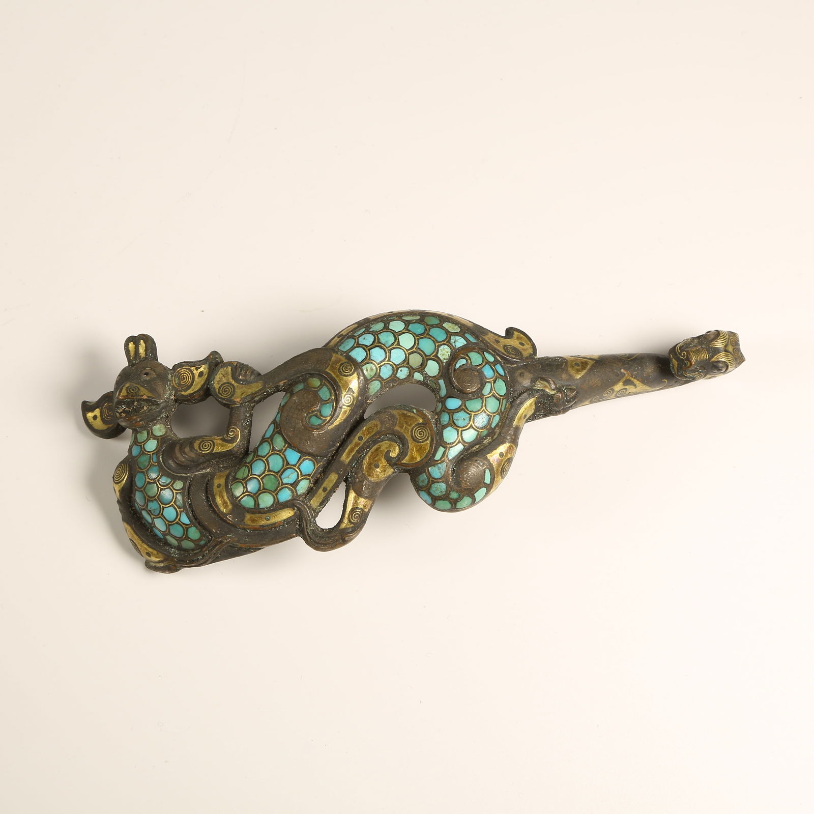 A BRONZE BELT HOOK WITH GOLD-AND-SILVER INLAY AND TURQUOISE: Bronze Belt Hook with Gold-and-Silver Inlay and Turquoise