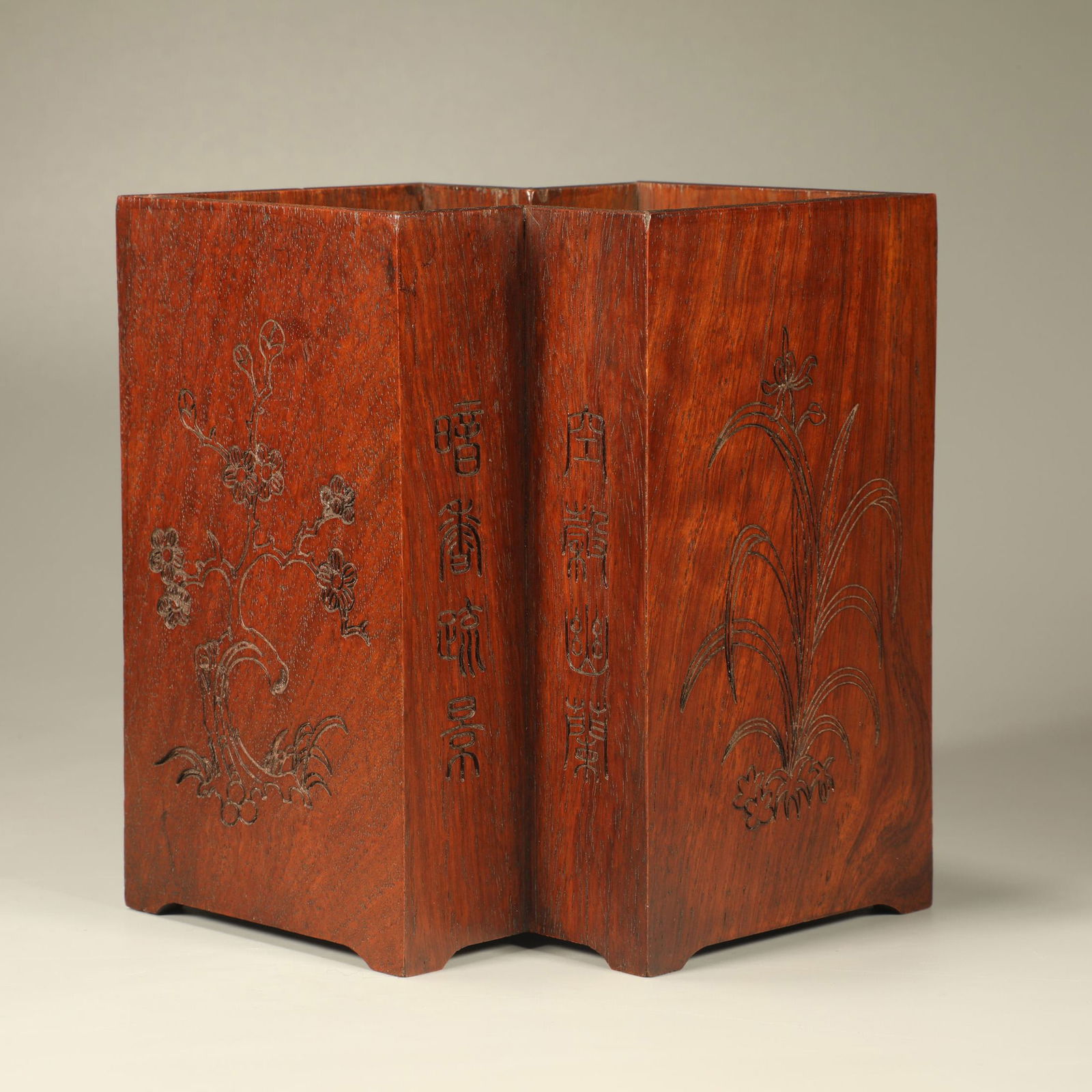 A HUANGHUALI CARVED DIAMOND-FORM BRUSH POT WITH PLUM, ORCHID, BAMBOO, AND CHRYSANTHEMUM MOTIF (1 of 6)