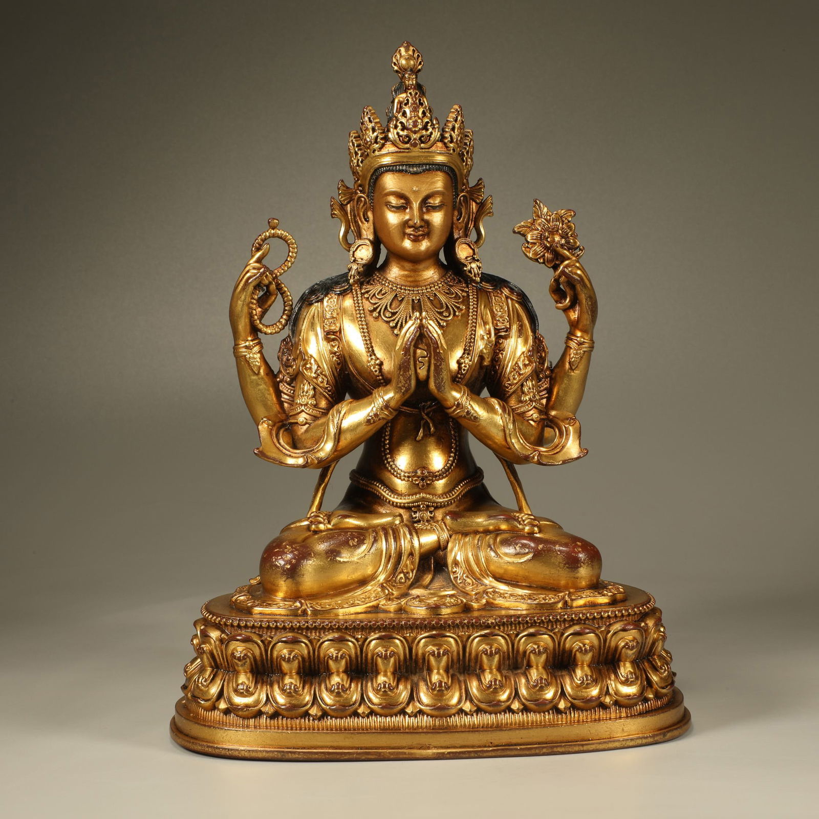A GILT-BRONZE FOUR-ARMED GUANYIN FIGURE: Gilt-Bronze Four-Armed Guanyin Figure