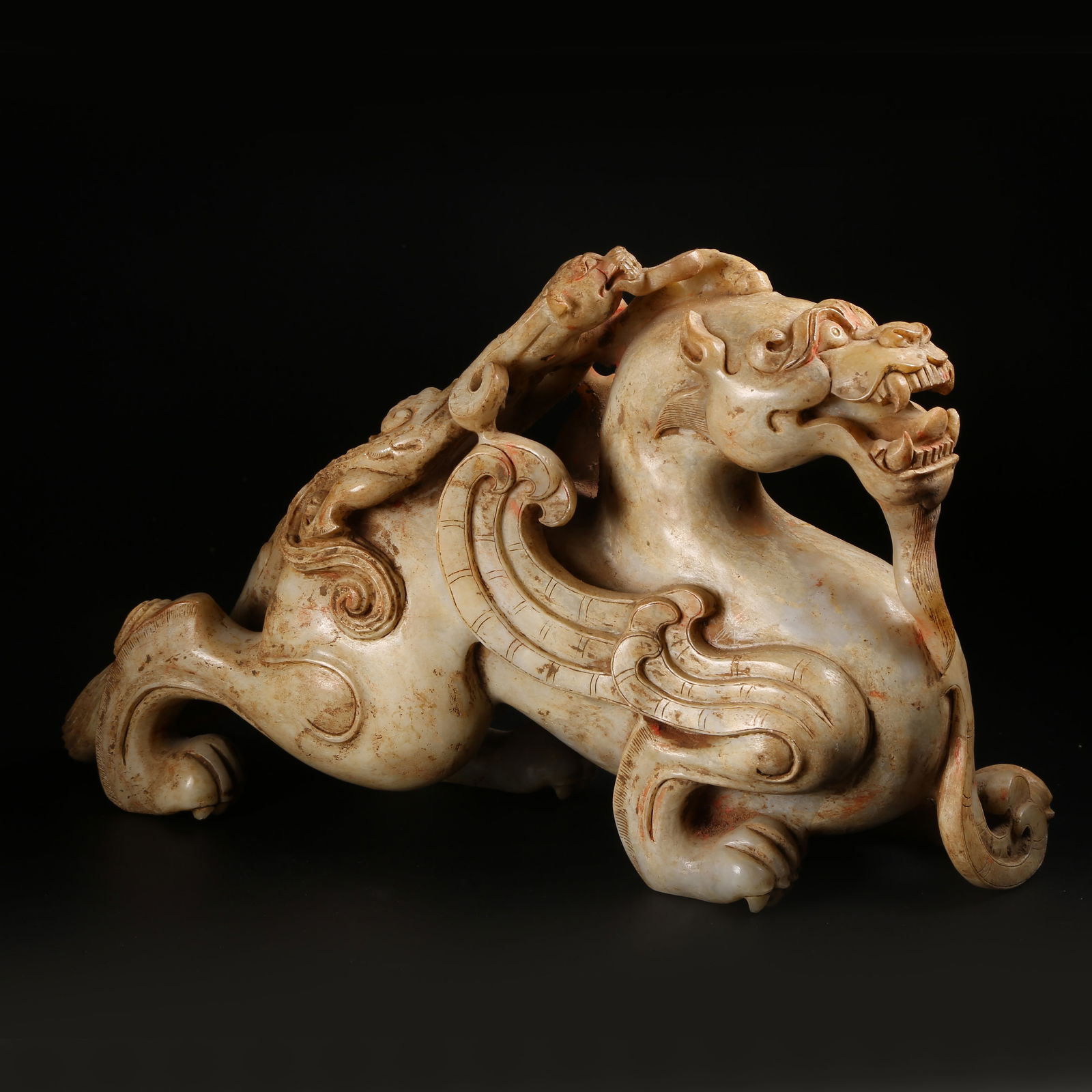 A ARCHAIC JADE AUSPICIOUS BEAST ORNAMENT (1 of 9)