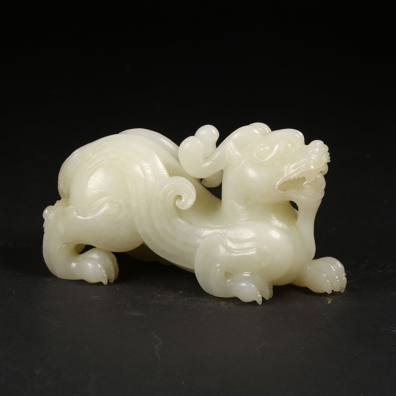 A HETIAN JADE AUSPICIOUS BEAST ORNAMENT (1 of 8)