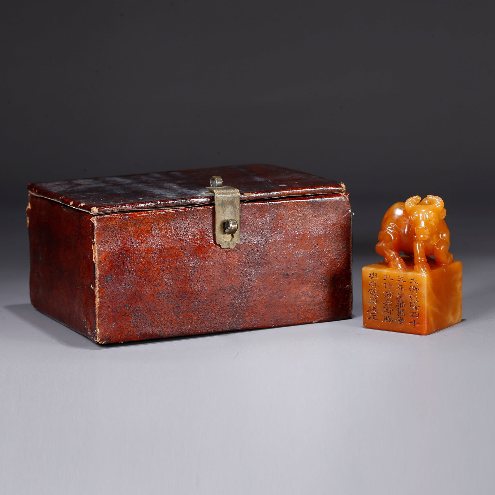 A SHOUSHAN TIANHUANG STONE SEAL WITH OX-HERDING MOTIF KNOB: Shoushan Tianhuang stone seal with ox-herding motif knob