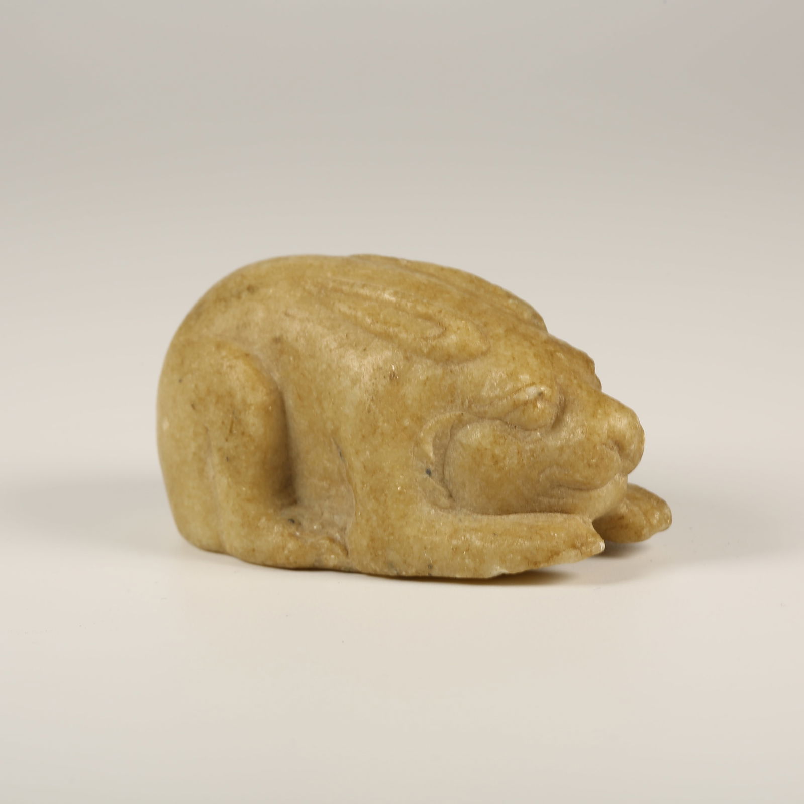 A RECUMBENT RABBIT ORNAMENT IN HAN WHITE JADE: Recumbent Rabbit Ornament in Han White Jade