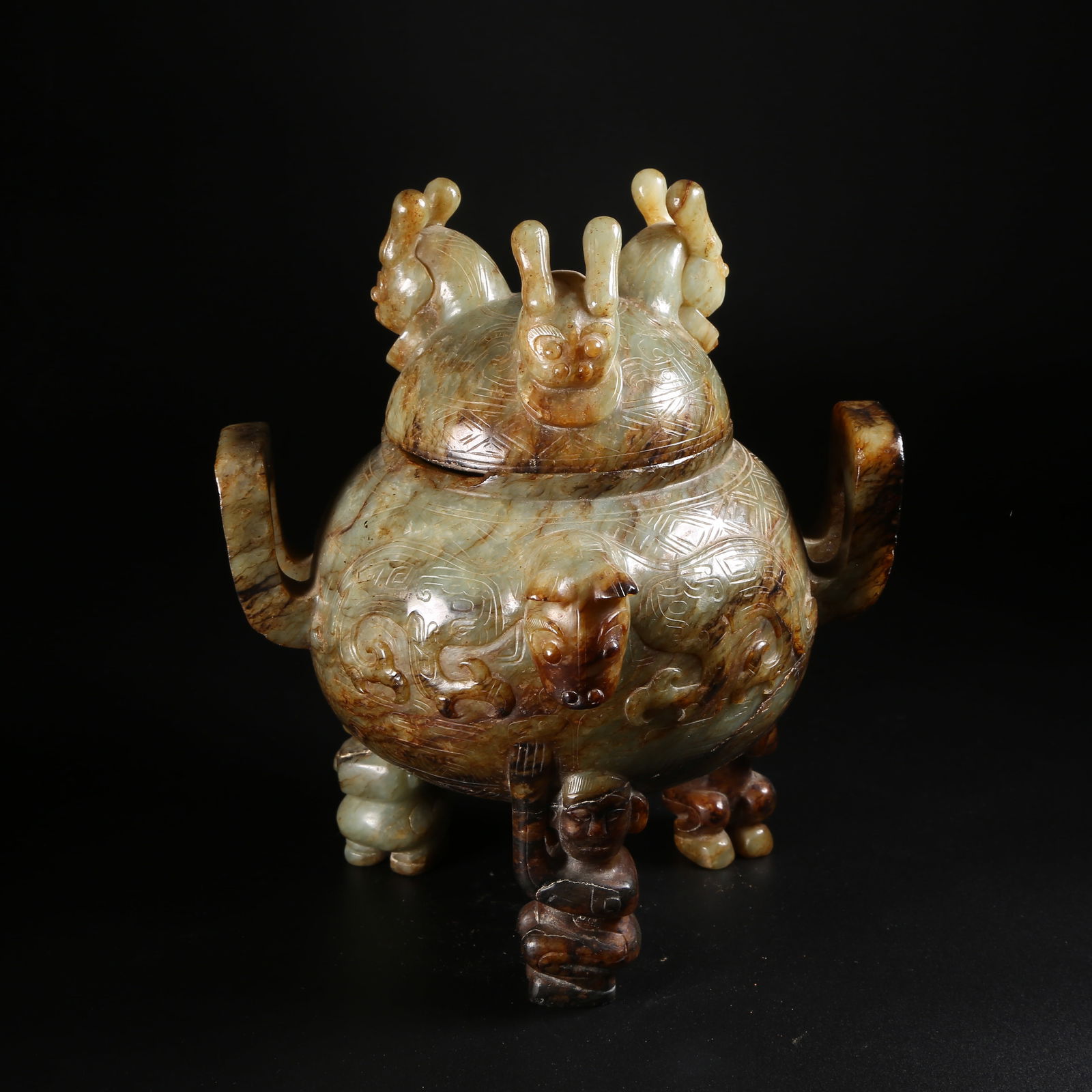 A ARCHAIC JADE TRIPOD CENSER WITH AUSPICIOUS BEAST MOTIFS AND "COURT-CAP" EARS: Archaic jade tripod censer with auspicious beast motifs and "court-cap" ears