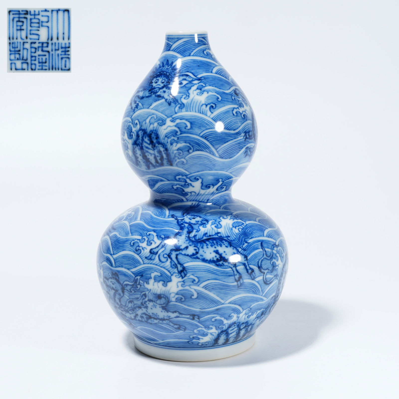 A BLUE-AND-WHITE GOURD-FORM VASE WITH SEA-AND-DRAGON MOTIF: Blue-and-White Gourd-Form Vase with Sea-and-Dragon Motif