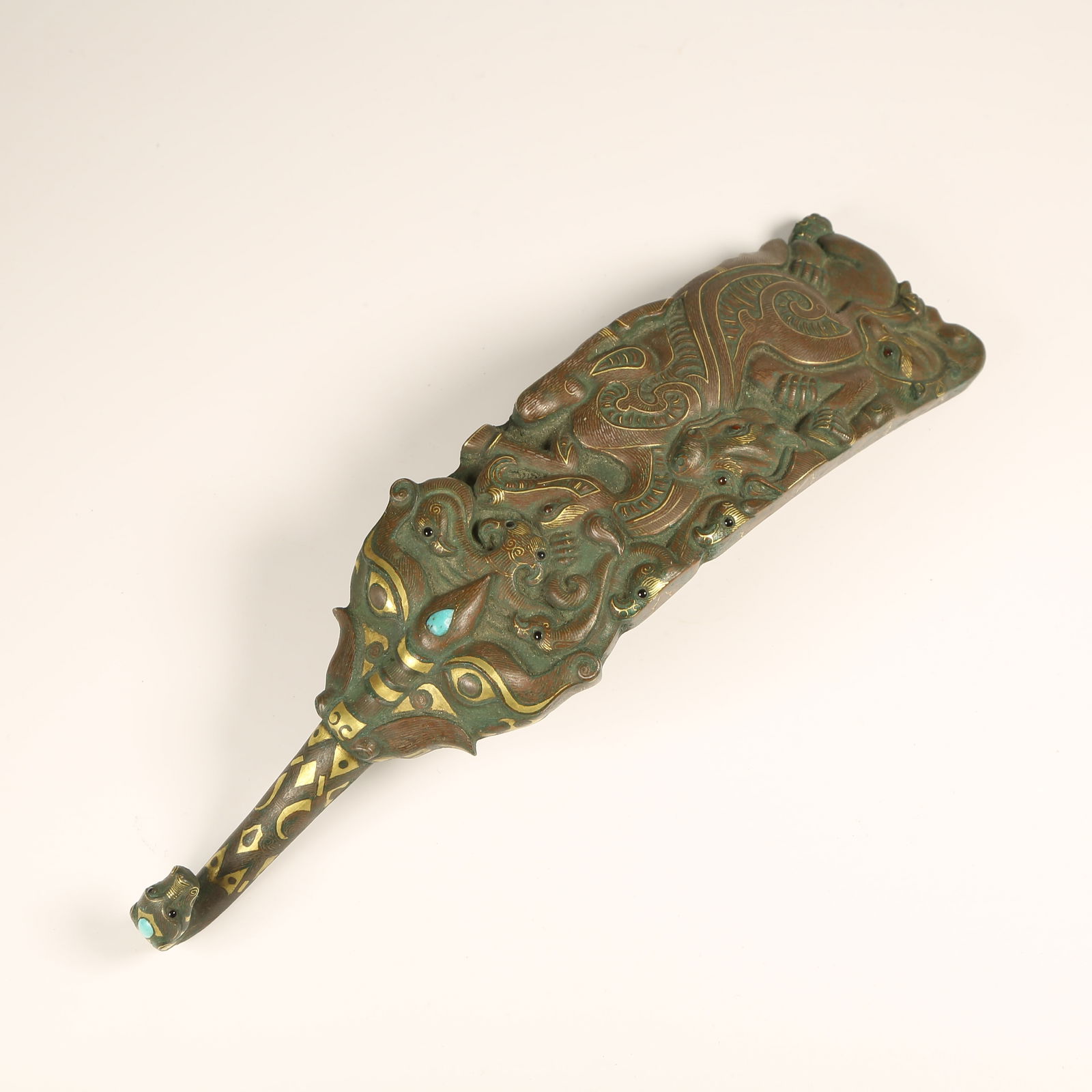 A BRONZE BELT HOOK WITH GOLD-AND-SILVER INLAY AND TURQUOISE AUSPICIOUS BEAST MOTIF: Bronze Belt Hook with Gold-and-Silver Inlay and Turquoise Auspicious Beast Motif