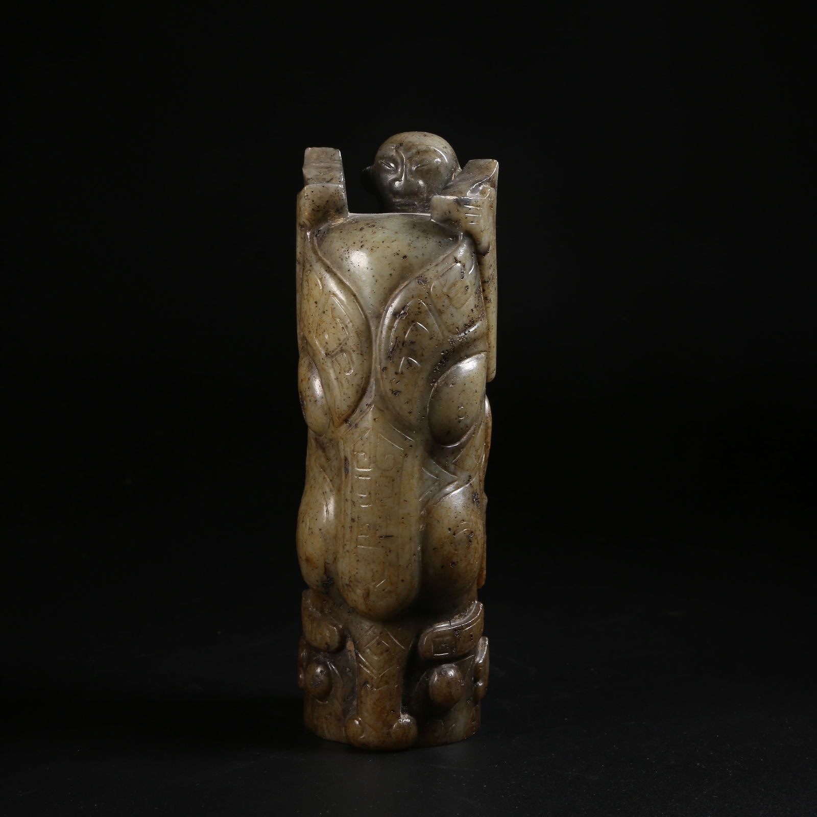 A ARCHAIC JADE AUSPICIOUS BEAST WEARING A COURT-CAP: Archaic jade auspicious beast wearing a court-cap