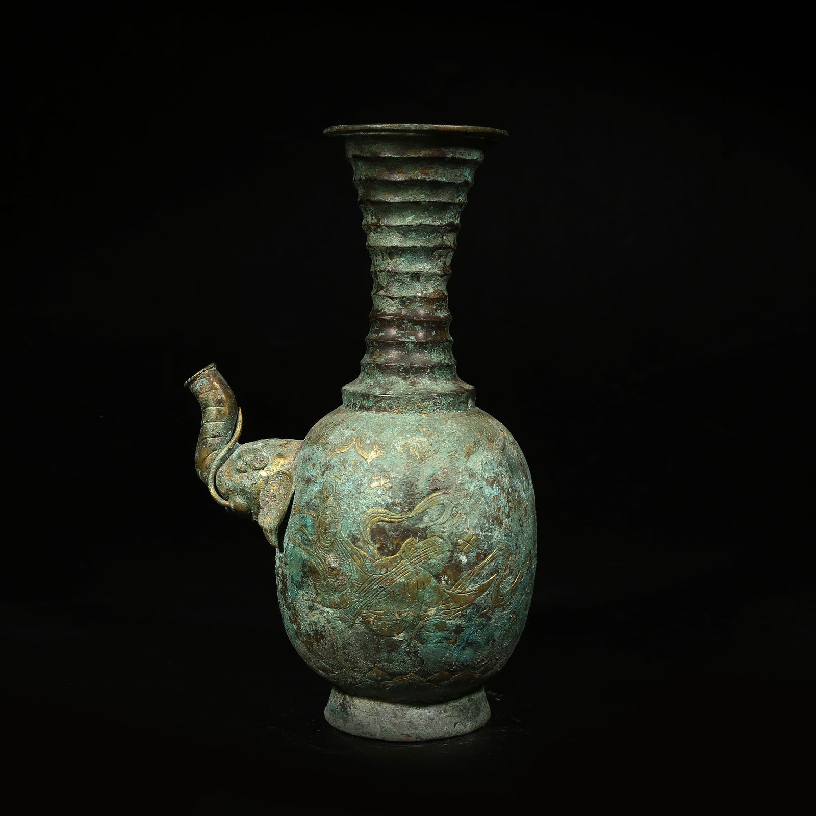 A BRONZE EWER WITH ELEPHANT-HEAD SPOUT AND PARTIAL GILDING: Bronze ewer with elephant-head spout and partial gilding