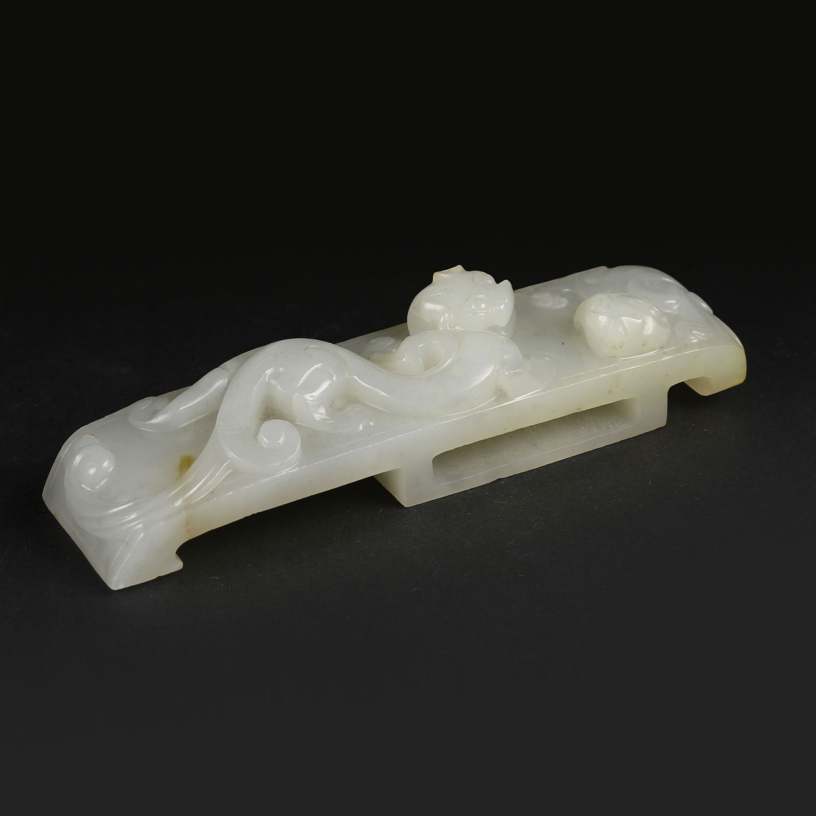 A HETIAN JADE SWORD FITTING WITH CHI-DRAGON MOTIF (1 of 8)
