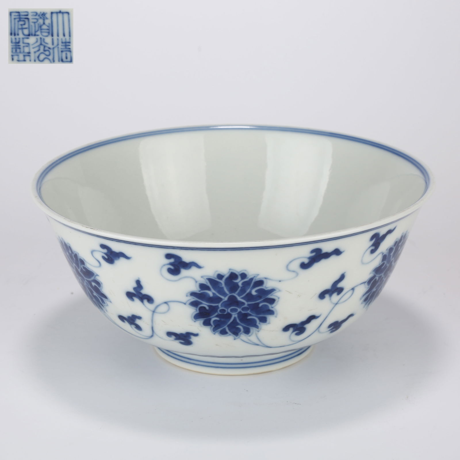 A BLUE-AND-WHITE BOWL WITH SCROLLING LOTUS DESIGN: Blue-and-white bowl with scrolling lotus design