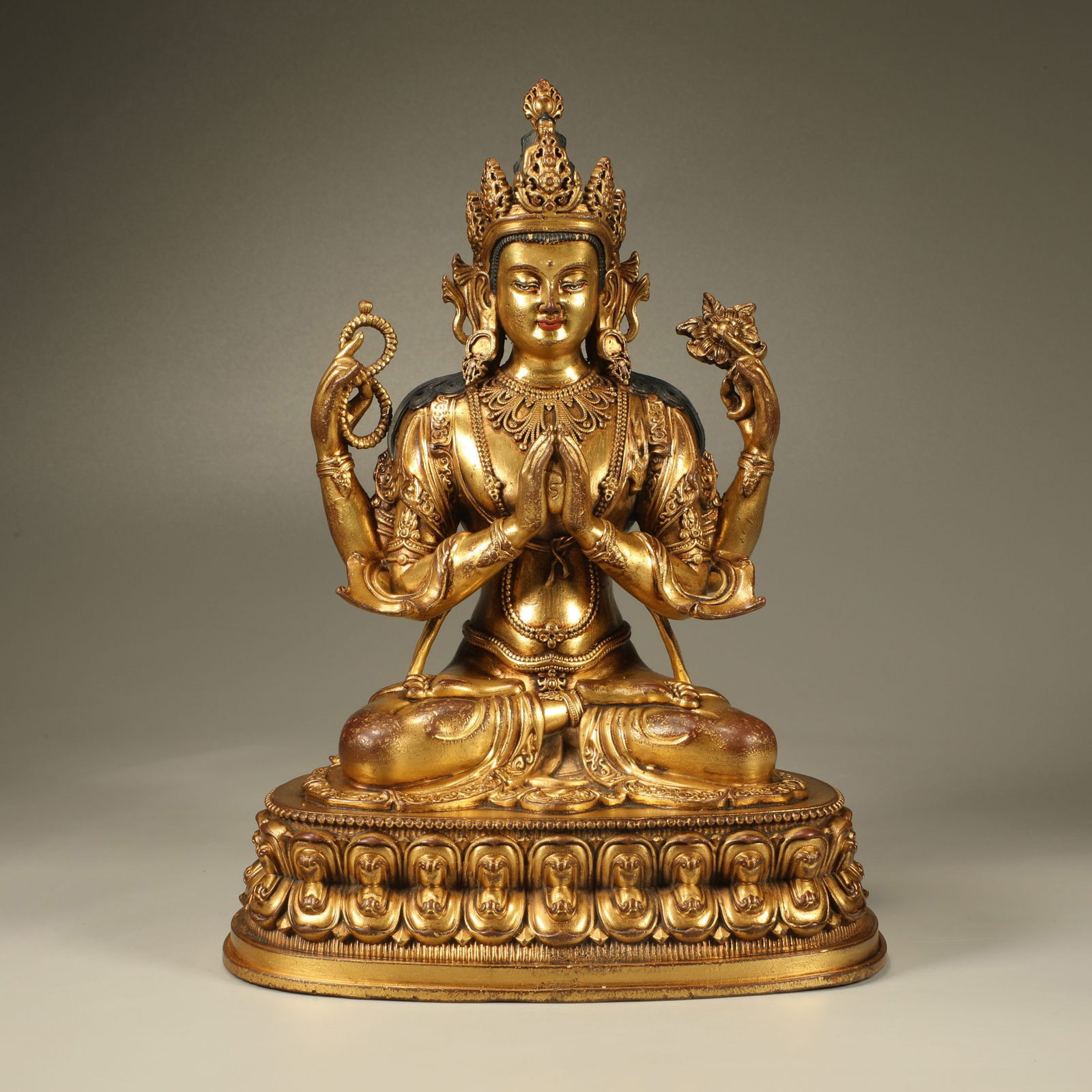 A GILT-BRONZE FOUR-ARMED GUANYIN FIGURE (1 of 7)