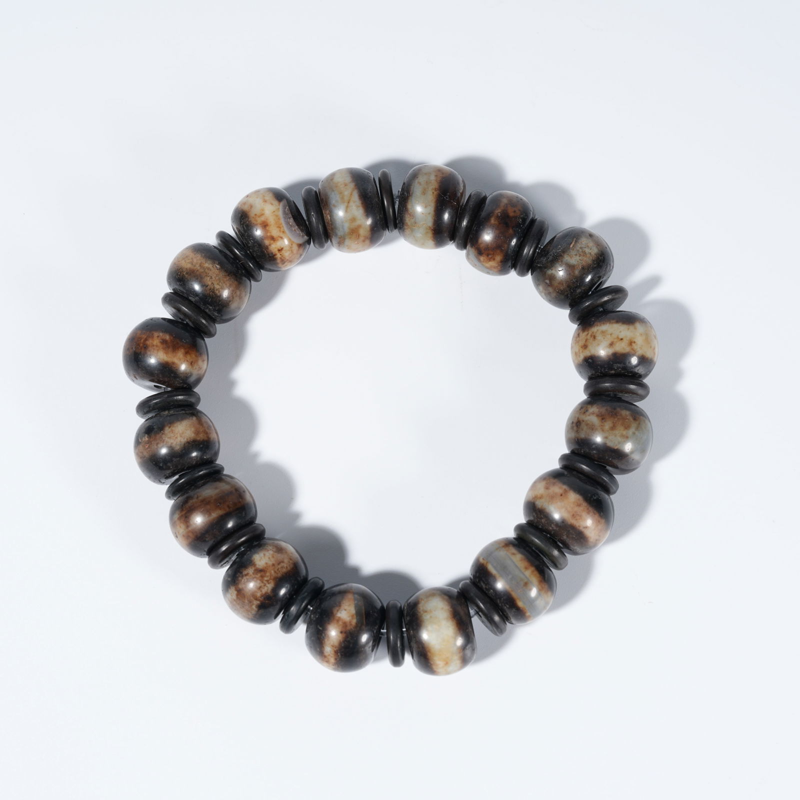 A MEDICINE BUDDHA DZI BEAD BRACELET (1 of 9)