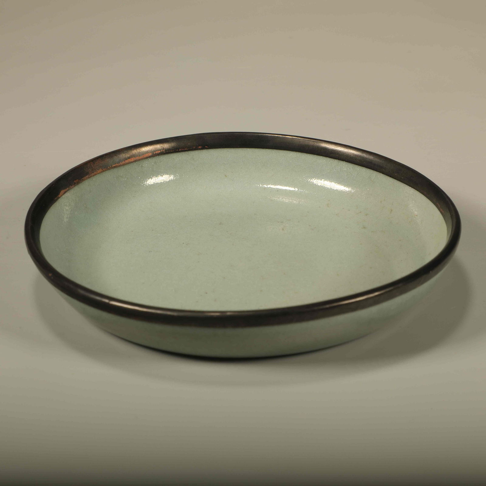 A RU KILN CRACKLE-GLAZED PLATE WITH BUTTON MOTIF: Ru Kiln Crackle-Glazed Plate with Button Motif