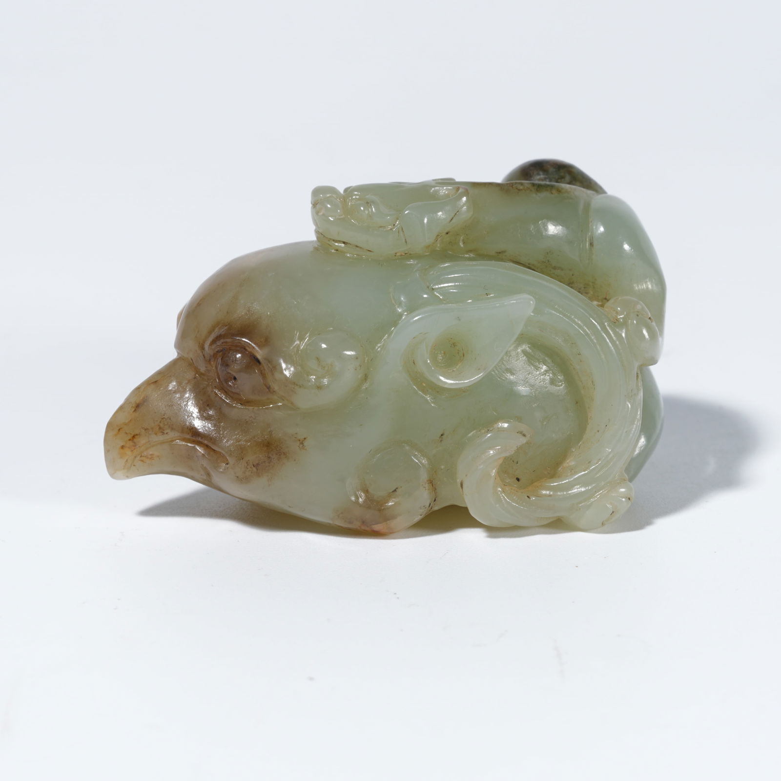 A HETIAN JADE CARVED PHOENIX-HEAD FIGURE (1 of 10)