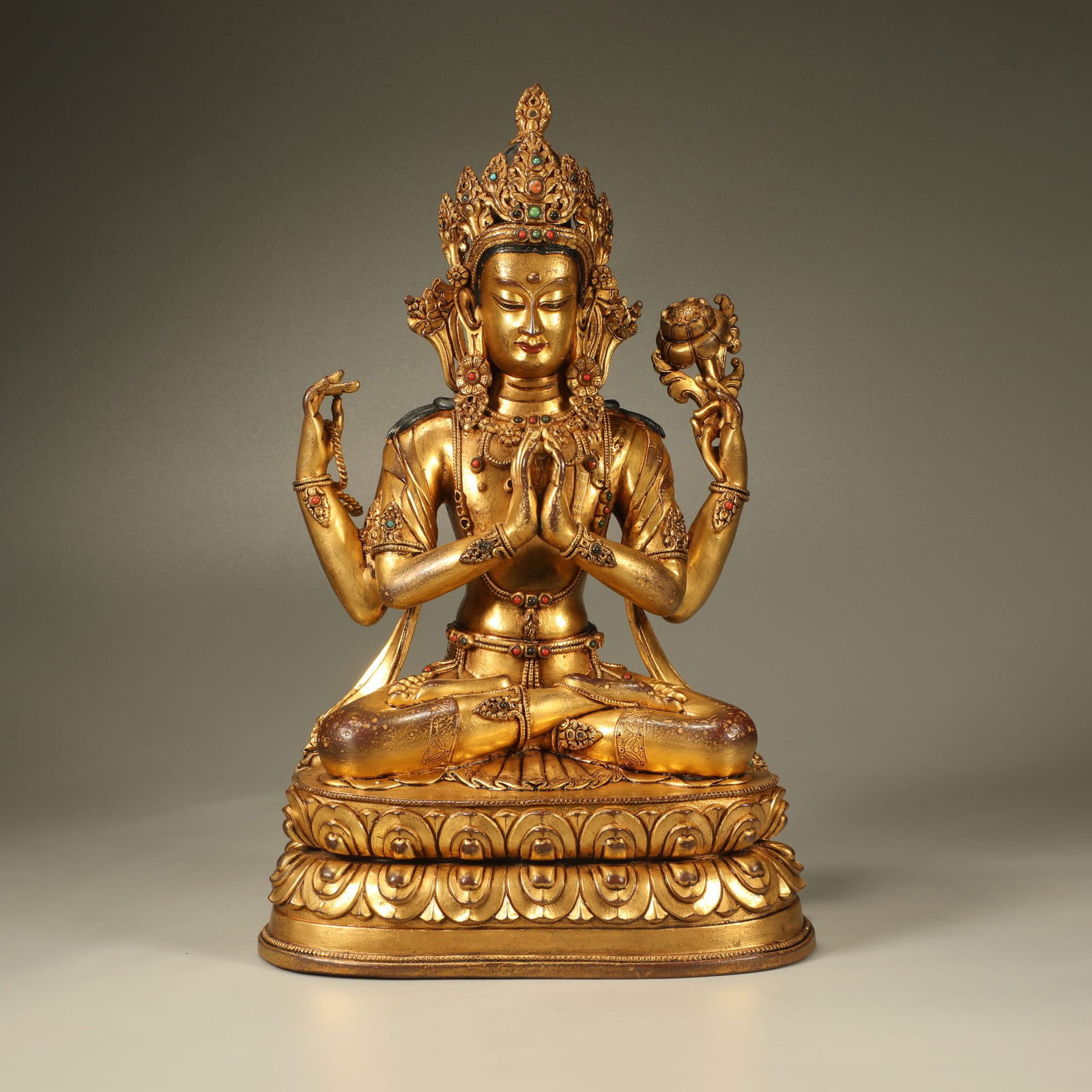 A GILT-BRONZE FOUR-ARMED GUANYIN FIGURE: Gilt-Bronze Four-Armed Guanyin Figure