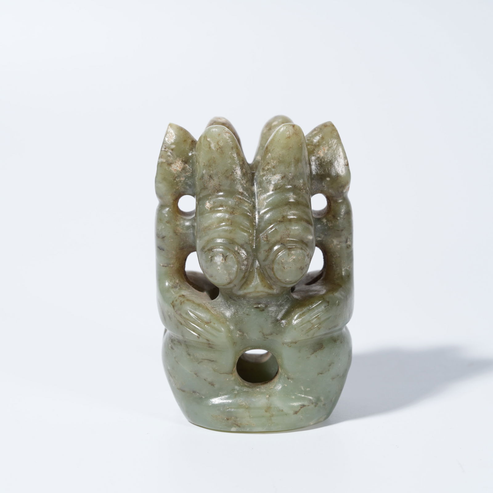 A ARCHAIC JADE CARVED SUN DEITY FIGURE (1 of 9)