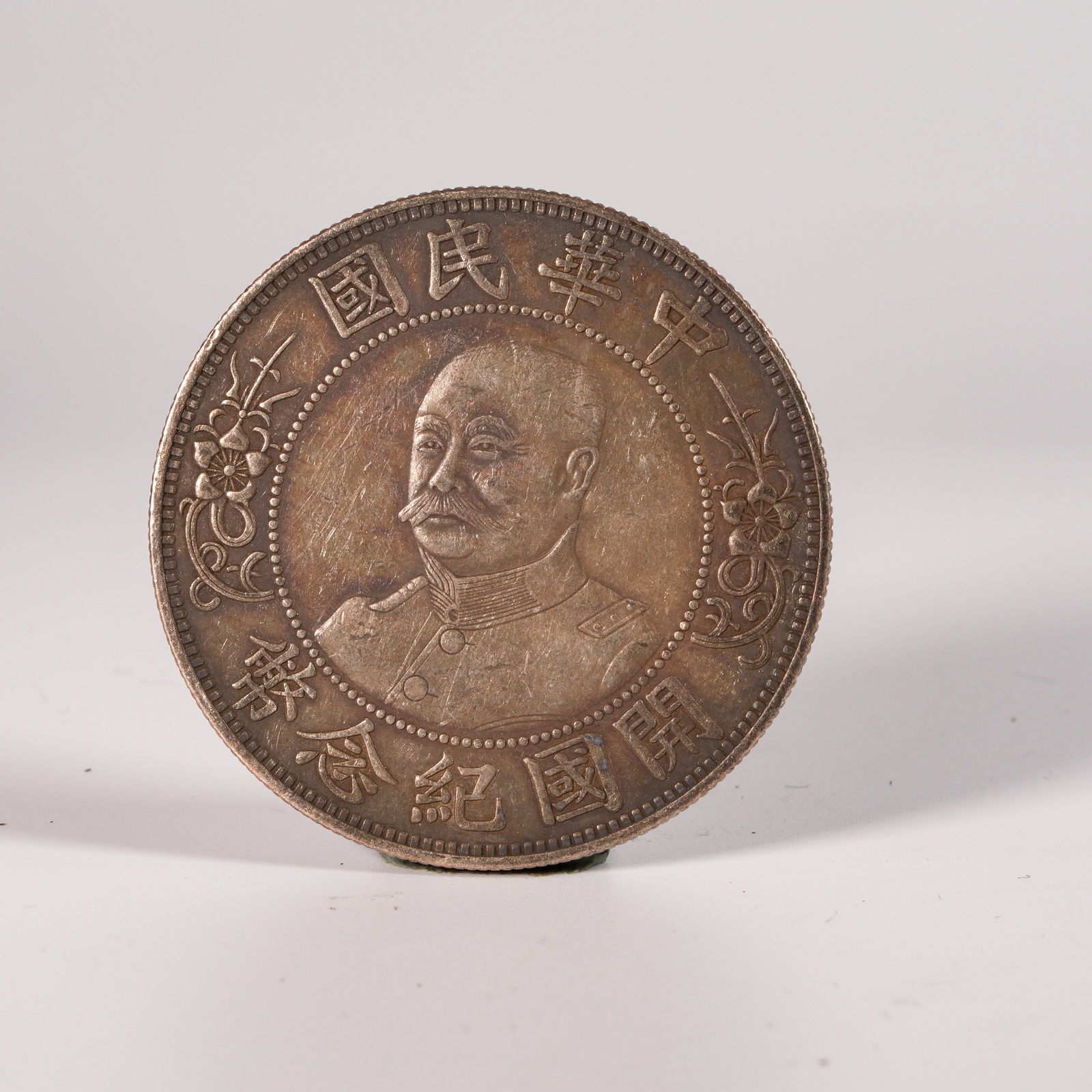 A SILVER DOLLAR COIN: One Silver dollar Coin