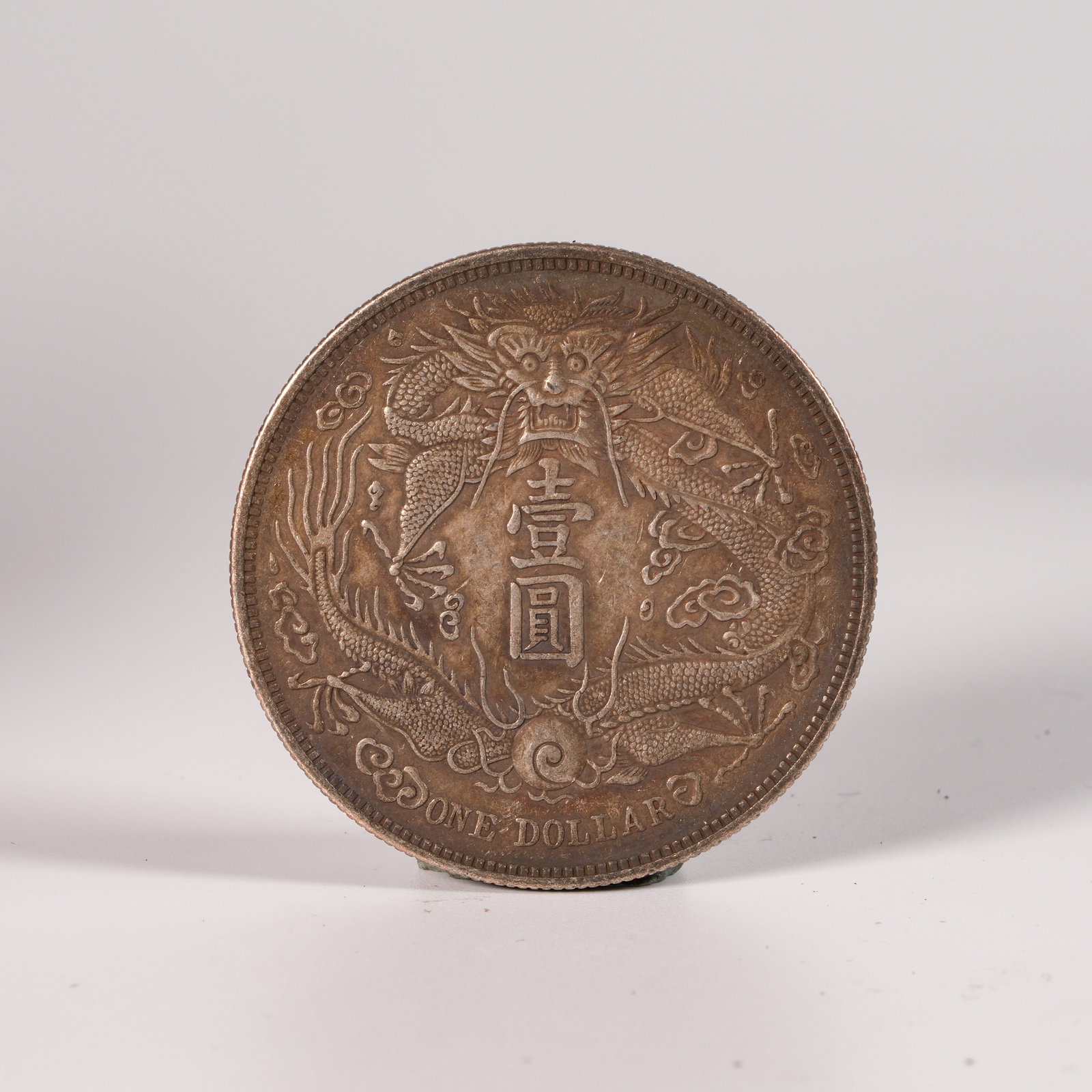 A SILVER DOLLAR COIN: One Silver dollar Coin