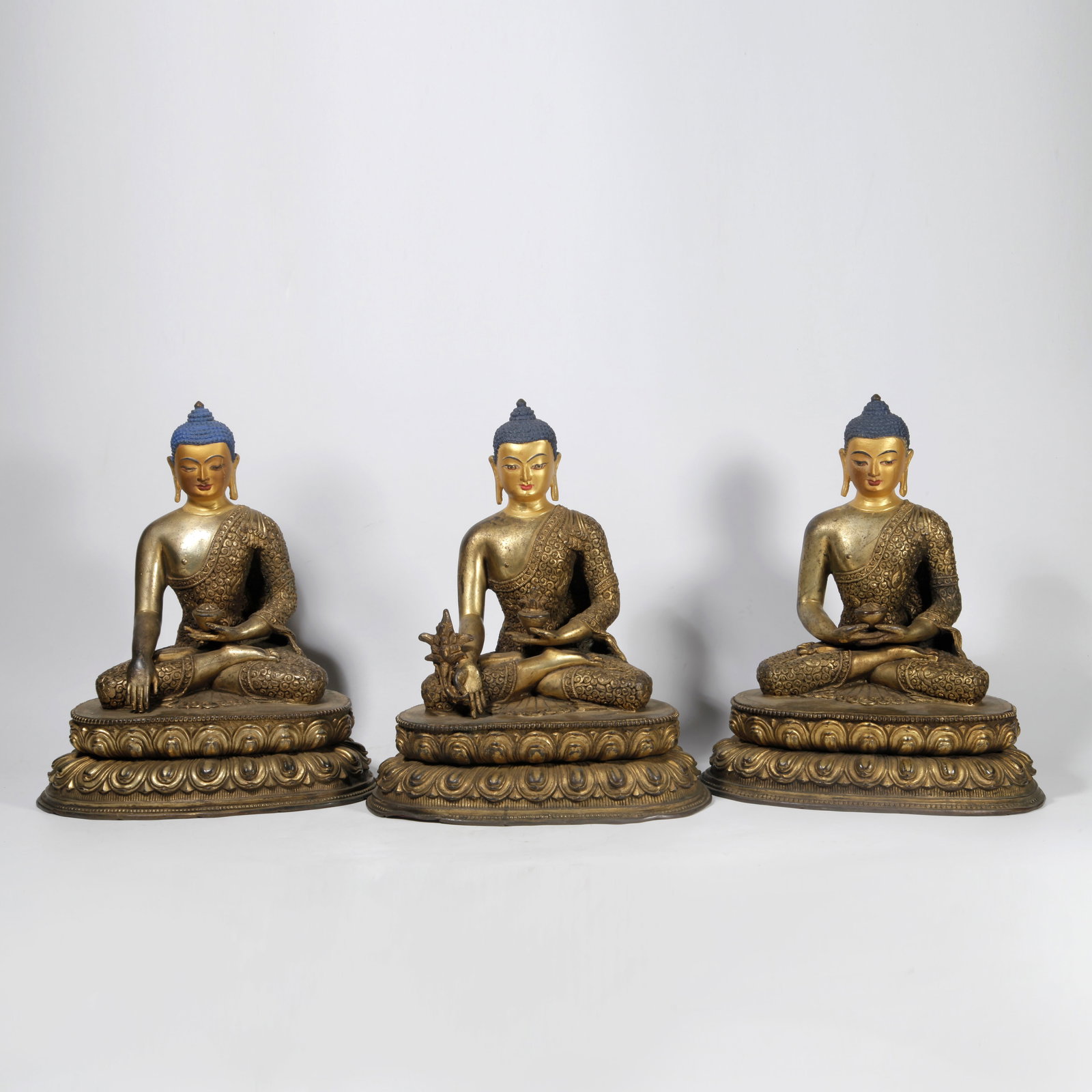 A GILT BRONZE SHAKYAMUNI STATUE SET: Gilt Bronze Shakyamuni Statue Set