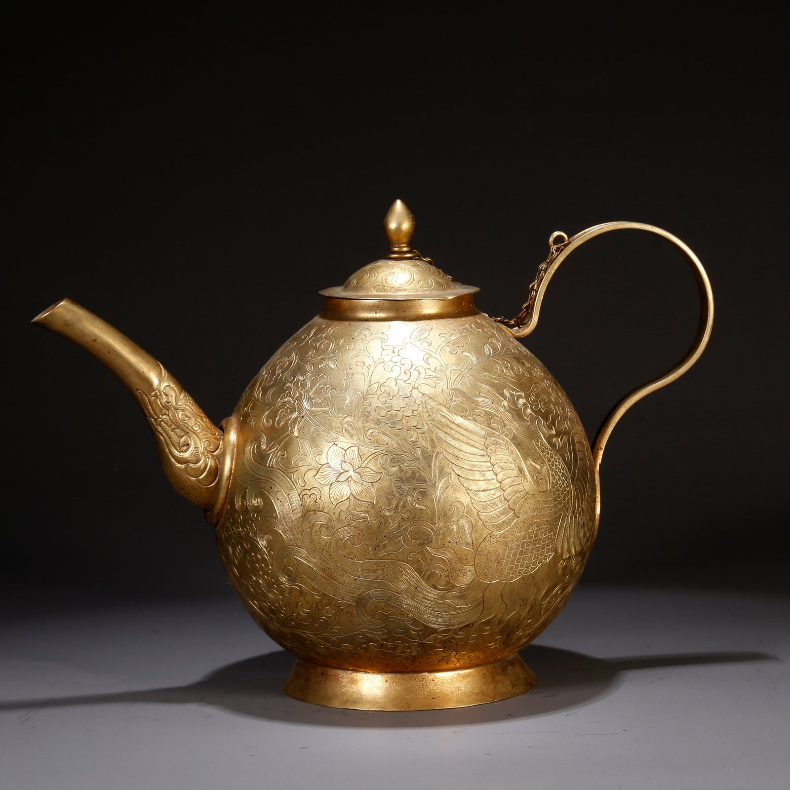 A GILT BRONZE EWER WITH PHOENIX MOTIF: Gilt bronze ewer with phoenix motif