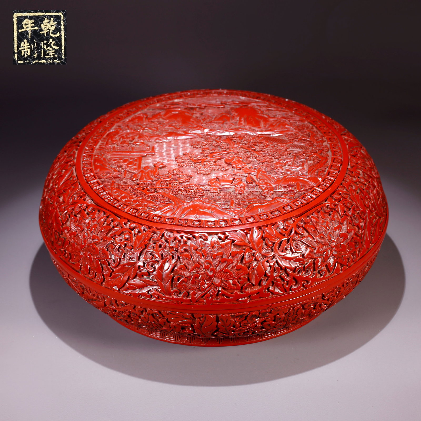 A CARVED RED LACQUER COVERED BOX WITH LANDSCAPE AND FIGURATIVE DESIGN (1 of 9)