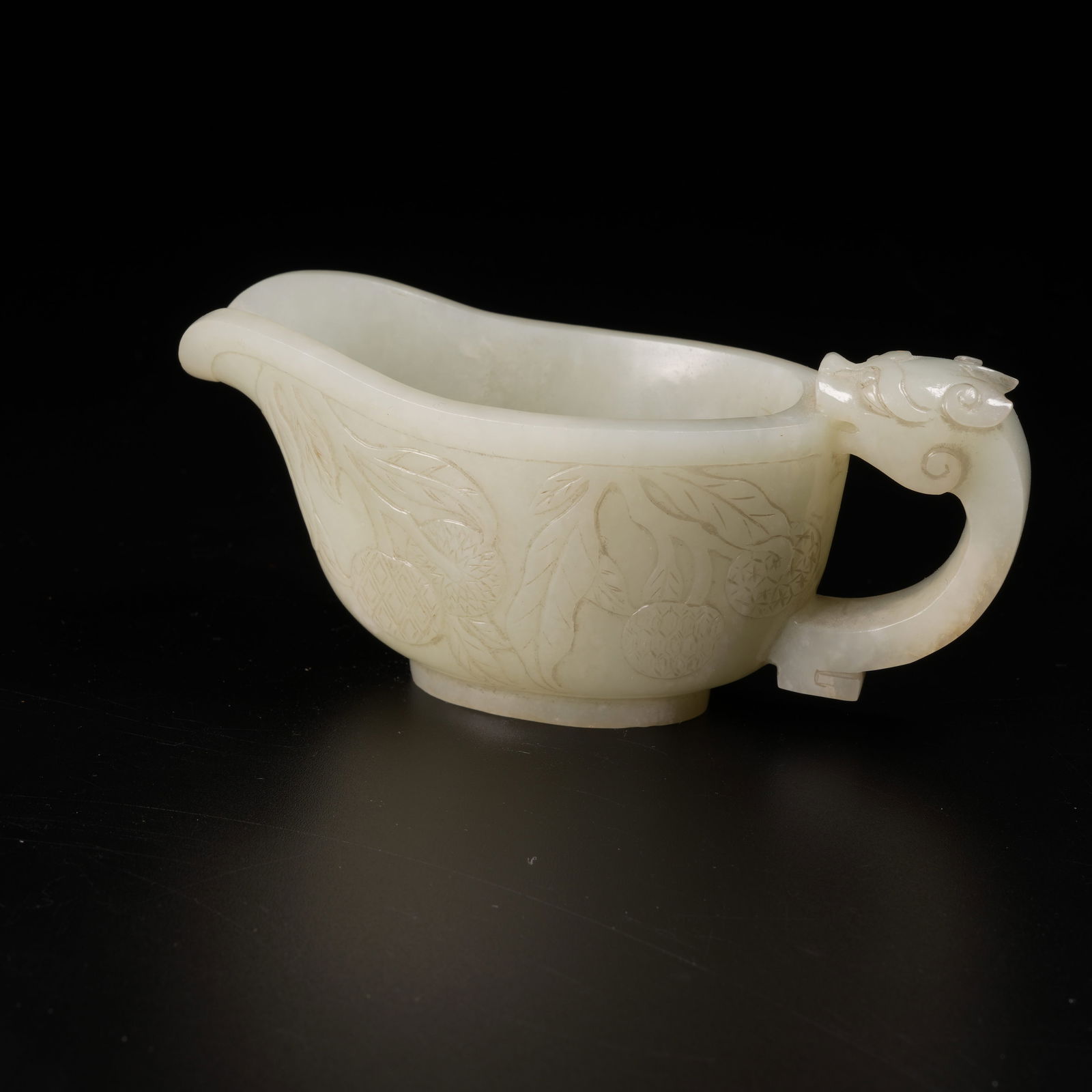 A HETIAN JADE JUE CUP WITH DRAGON-HANDLE AND AUSPICIOUS FRUIT MOTIFS (1 of 9)