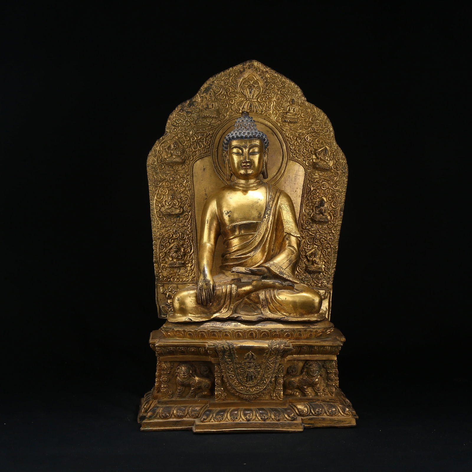 A GILT BRONZE FIGURE OF SHAKYAMUNI BUDDHA: Gilt Bronze Figure of Shakyamuni Buddha